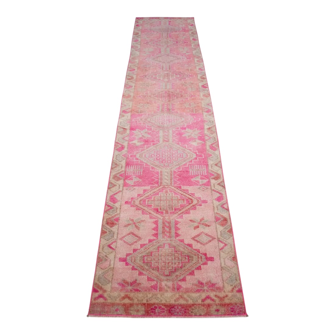 1960s Hand Knotted Kurdish Tribal Low Pile Runner: Offered is a gorgeous Kurdish runner rug, made in Hakkari approximately 40-50 years ago. The beautiful wool on wool pile features multicolored geometric patterns on a wavy pink background. Dimension: