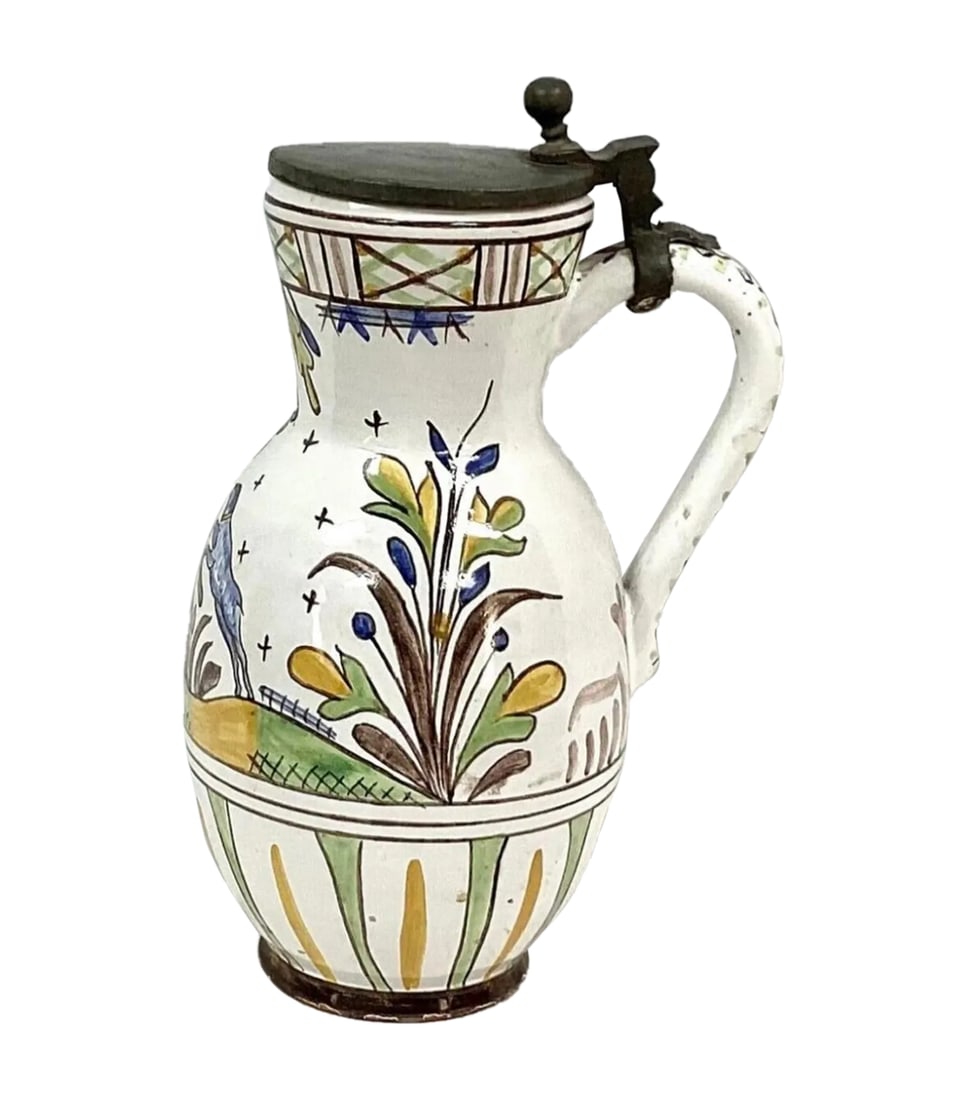 Faience Polychrome Decorated Beer Stein With Pewter Lid and Handle: German Faience pitcher/jug with hinged pewter lid and handle. Hand painted floral design, along with stag and dog, on white background. Top of lid is monogrammed. Has minor wear from lid on rim of