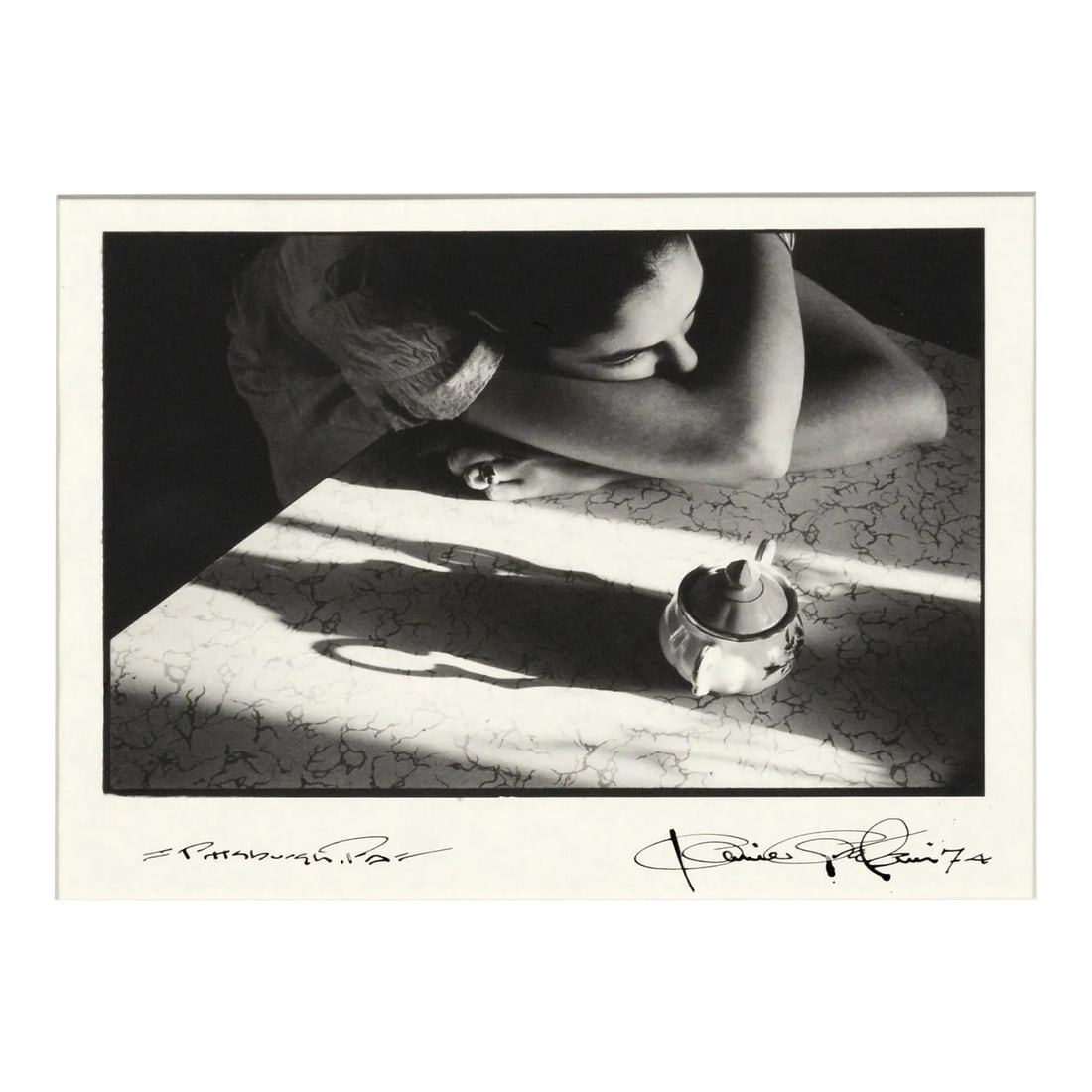 Portrait of a Woman With Teapot, 1970s Pittsburgh Black & White Photograph: Compelling 1970s black and white photograph of a contemplative woman leaning on a table into her crossed arms, beside a small teapot that casts a long shadow, by an unknown artist (American, 20th