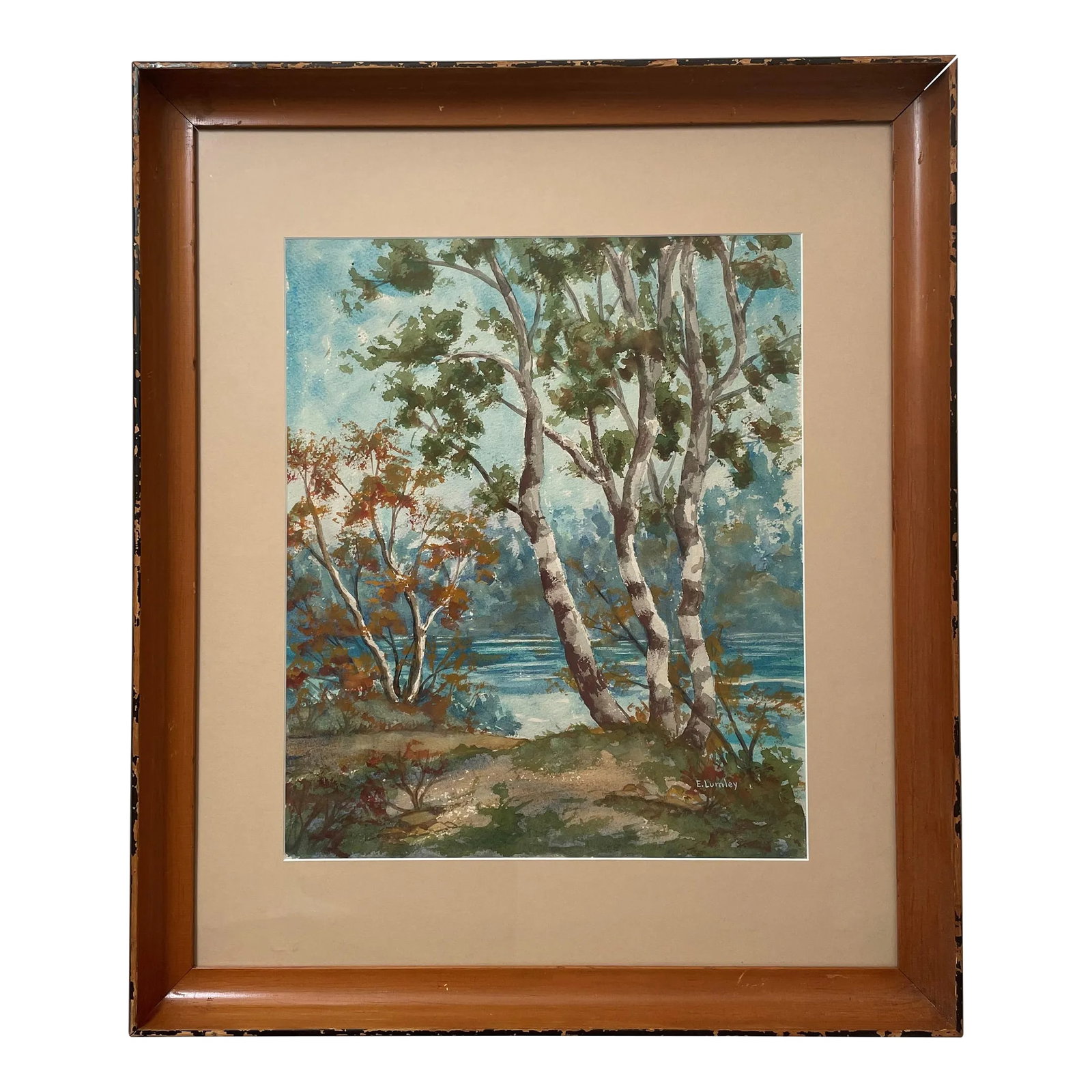 Watercolor Landscape by E. Lumley: A beautifully painted landscape highlighting trees against a serene blue lake. Condition: Alterations: Original Condition Unaltered Imperfections: Some Imperfections Condition Notes: Painting is in