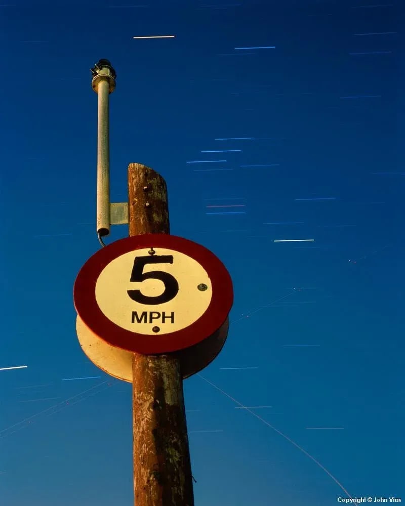 Contemporary Night Photograph "Slow Down" by John Vias: Note from the artist, John Vias: "One goal in my work is to encourage people to slow down and appreciate the beauty that surrounds us every day." This 10" x 8" archival color photograph is presented