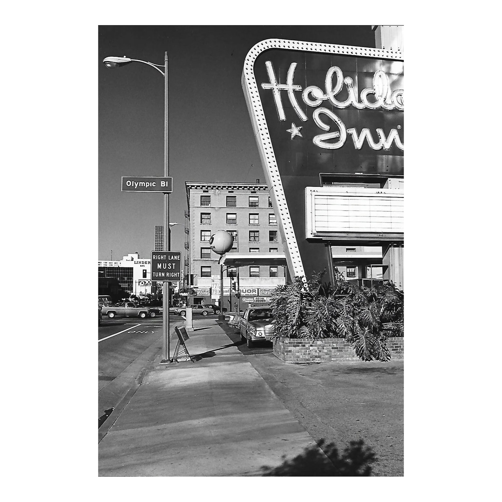 1979 Downtown Holiday Inn Los Angeles Photograph by Don Ware: 1979 black and white photo by Los Angeles, California photographer Don Ware of the intersection of Figueroa and Olympic Blvd with a Holiday Inn in the foreground and the Unions Bank Plaza in the dista