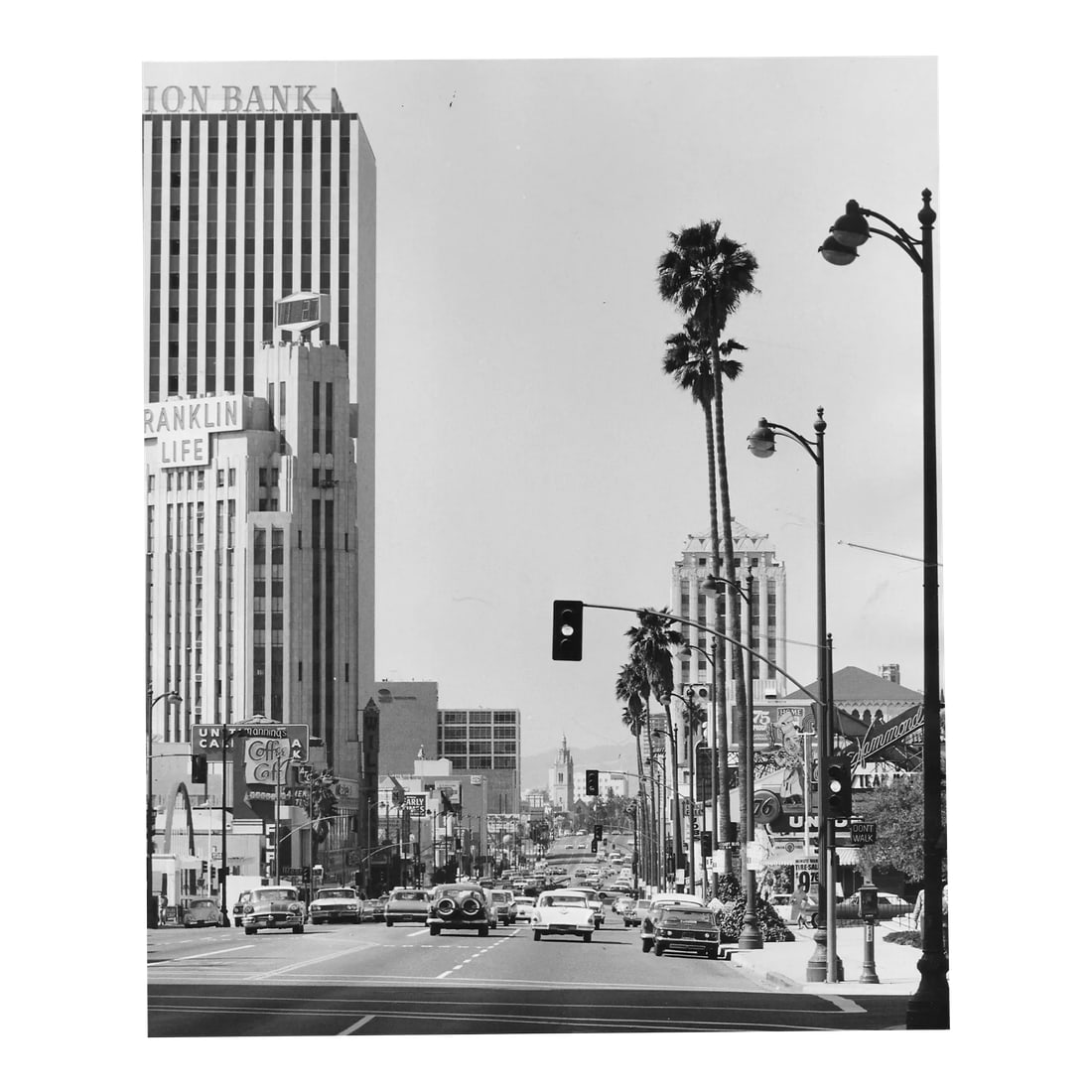 1970s Wilshire Boulevard Los Anglese Photograph by Don Ware: 1970s black and white photograph by Los Angeles, California based photographer Don Ware of Wilshire Blvd. looking west from Western Ave on the edge of Koreatown. Titled, dated and bearing Ware's