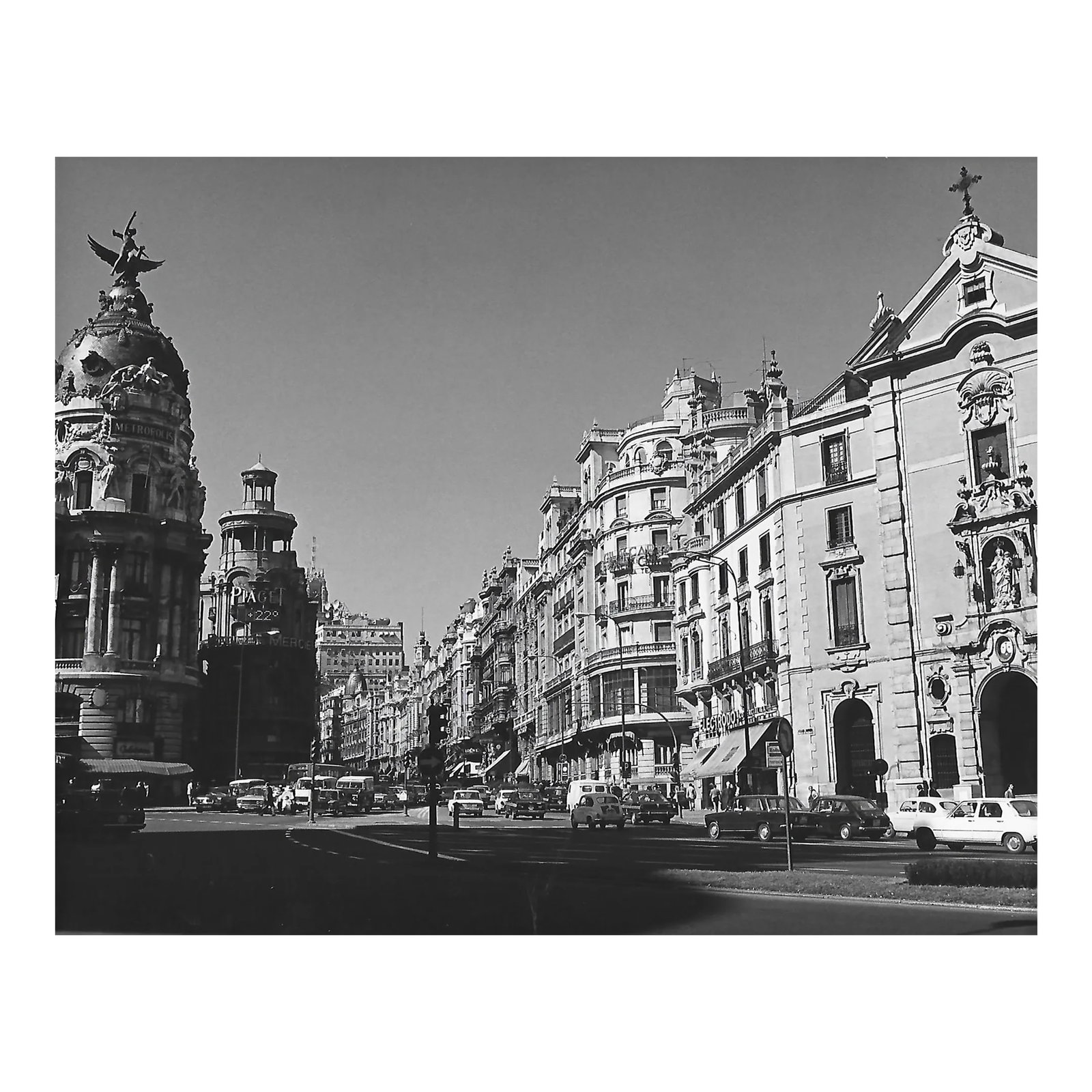 1976 Madrid Spanish Street Photograph by Don Ware: 1976 black and white photograph by Los Angeles based photographer Don Ware of the intersection of Gran Via and Calle de Alcala with the Metropolis Building (built 1911). Titled. dated and bearing Ware
