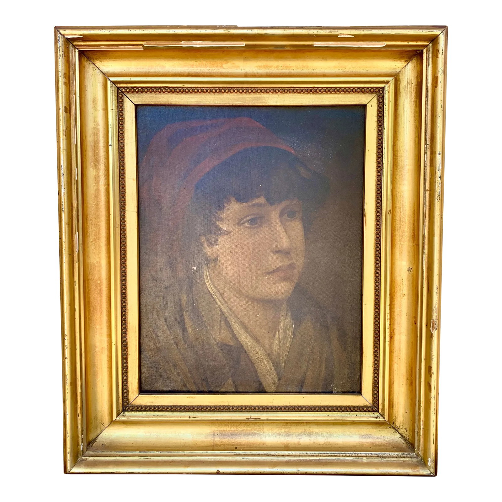Early 20th Century Italian Portrait of a Boy in Giltwood Frame: A quietly compelling early 20th century oil on canvas portrait depicting a young boy in a red cap, signed Mary E. Southard and presented in a broad giltwood frame. The restrained palette, direct