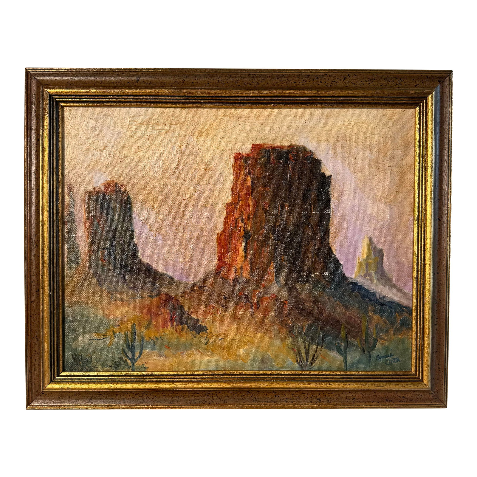 Vintage American Southwest Landscape Framed Original Oil Painting, Gold, Lavender, Burnt Orange: An eye catching recreation of an American Southwest landscape is captured in this exquisitely executed original oil signed and painted by Connie Orta. Red rust-colored rock cliff formations, forest