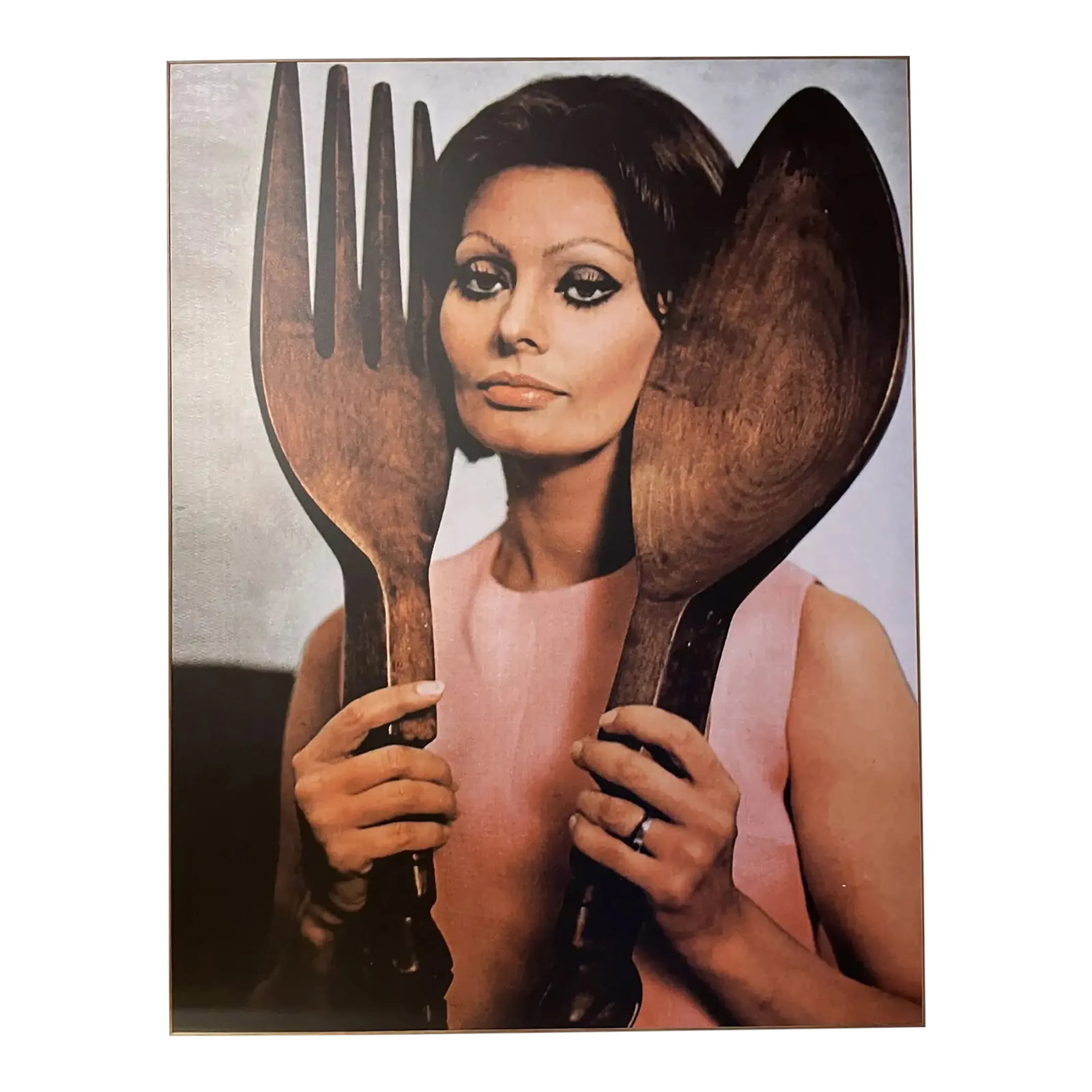 1960s "Sophia Loren With Large Spoon & Fork" Reproduction Photograph, Framed: Striking vintage portrait of Sophia Loren holding an iconic oversized wooden spoon and fork - a playful nod to mid-century Italian style and culinary culture. This vintage reproduction photograph