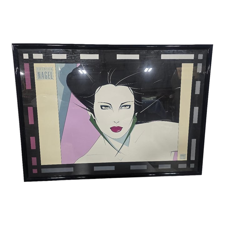 Vintage Patrick Nagel Mirage Editions Framed Art Print: Iconic 1980s Art Print by Patrick Nagel (published by Mirage Editions), featuring his signature stylized female portrait design. This large-format piece makes a bold statement in any modern, contempor