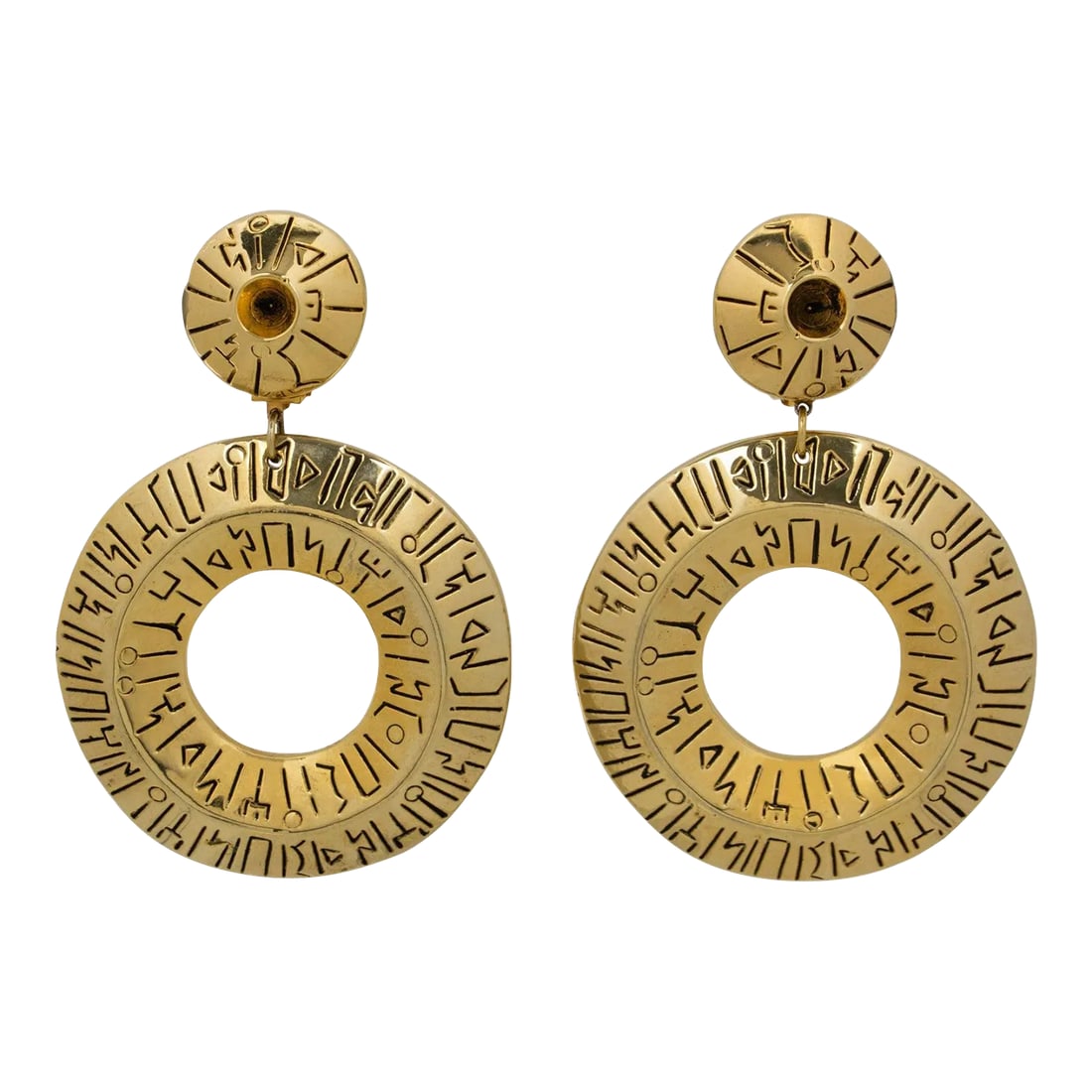 Francoise Montague Paris Oversized Gilded Resin Donut Dangle Pair of Clip Earrings: Stunning oversized Francoise Montague Paris resin clip-on earrings designed in the 1980s. A dangle shape features a massive gilt metal coating resin donut with ethnic carving. Shiny gold color with
