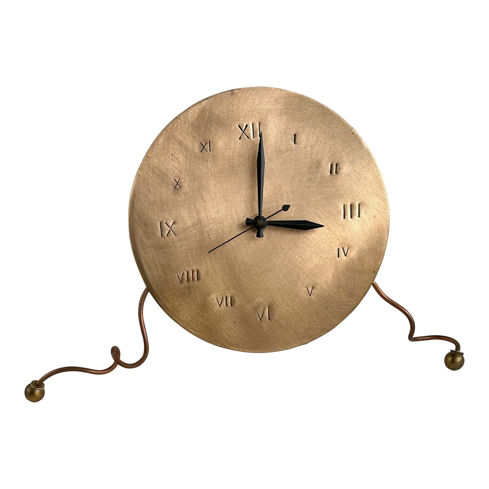 Brushed Copper Mantel Clock by Christopher Poehlmann 1993: This vintage clock has an 8" brushed face with hand-hammered Roman numerals. Crafted from a mixture of metals, this postmodern marvel is supported by whimsical curled feet. Japanese movement. It