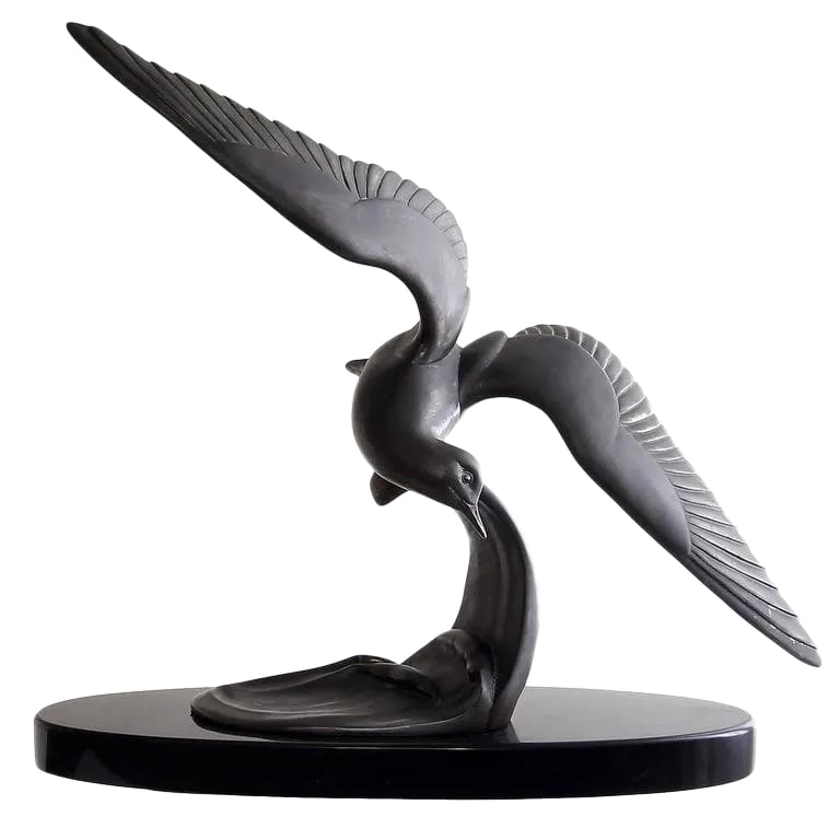 Vintage Mid-Century Art Deco Style Bronzed Spelter Seagull Sculpture: Beautiful Art Deco interpretation of a seagull in flight just above the waves. Patinated bronze spelter mounted on an oval black marble base. This is a beautiful example of this style that makes a gre