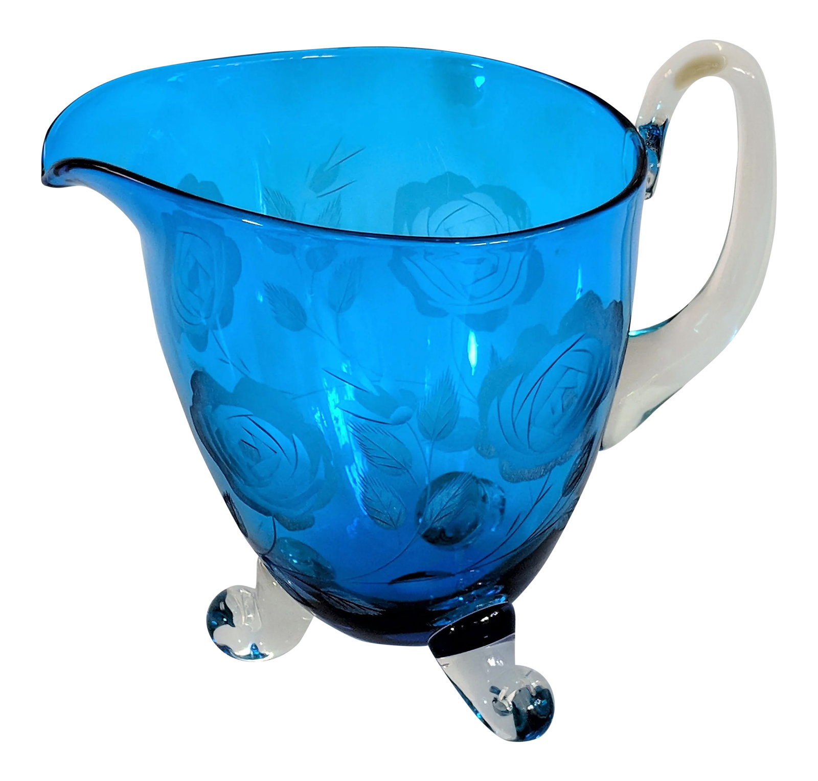 1960s Vintage Hand Blown Blue Glass Pitcher: Victorian Hand Blown Blue Glass Pitcher Vase with Etched Roses and Applied Handle and Feet. The shade of blue is truly stunning. Beautiful etched roses on the exterior. A unique and gorgeous piece to 
