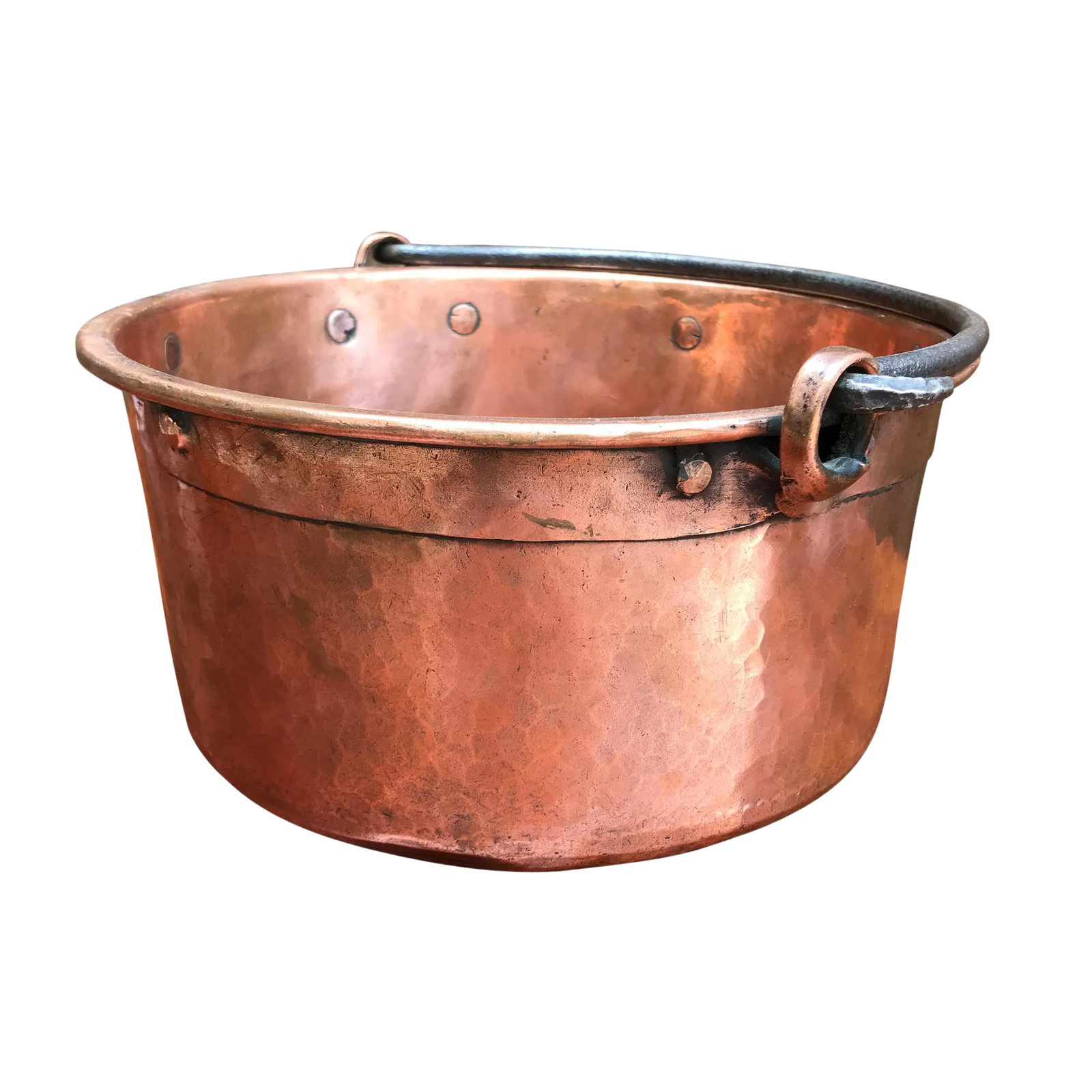 Early 19th Century French Hammered Copper Kettle: An early 19th century French hammered copper kettle with wide riveted copper straps, a thick hand-forged iron handle, and scalloped dovetail joinery around the bottom. Condition: Alterations: Original