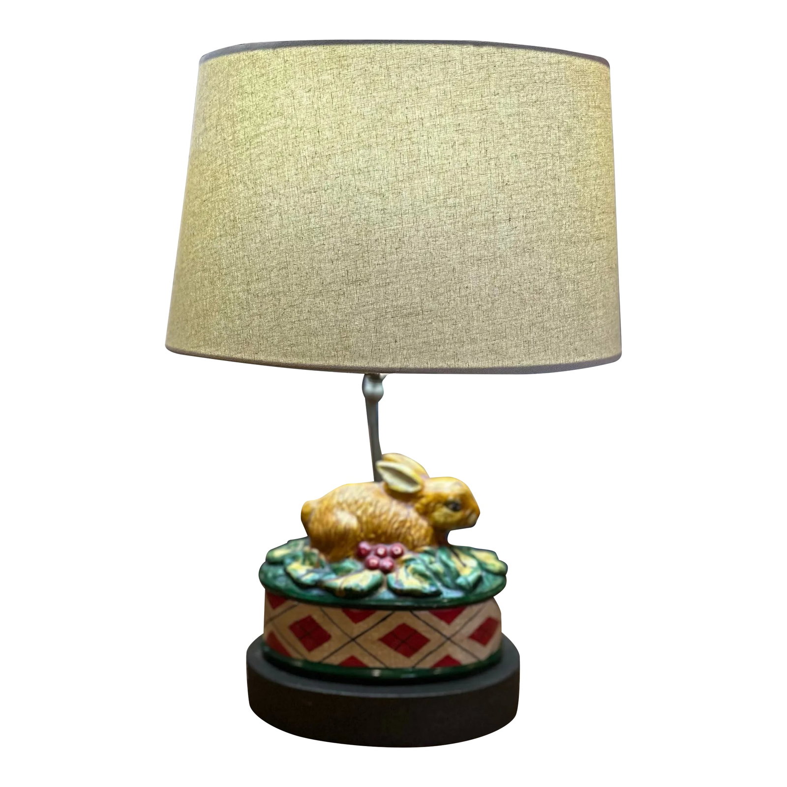 1930's Easter Bunny Lamp: Pretty little bunny majolica lamp. With new shade. 3way switch. Bunny is laying on a bed green and yellow leaves with red berries. On top of red and black plaid box with green rim. Some crazing in the