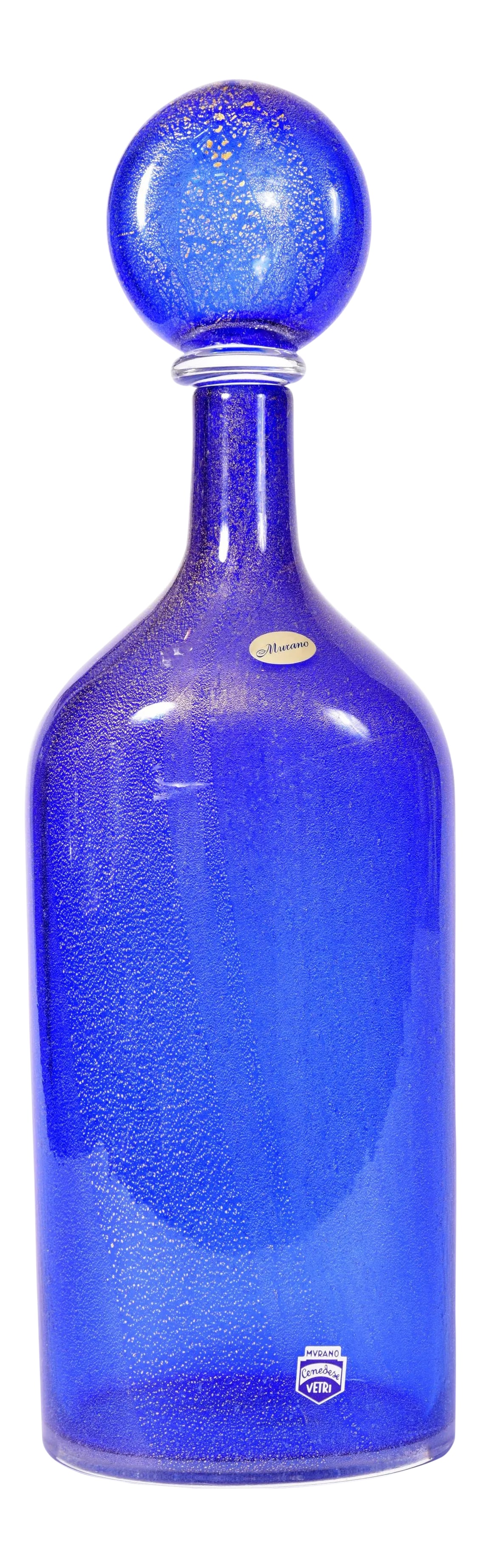 Vintage Cobalt Blue Murano Glass With Gold Flecks Decanter: Mid-20th century cobalt blue with gold fleck Murano glass decanter. The decanter is in excellent condition, maker's mark undersigned. The decanter stand about 16.5 inches X 5.5 inches X 3 inches.