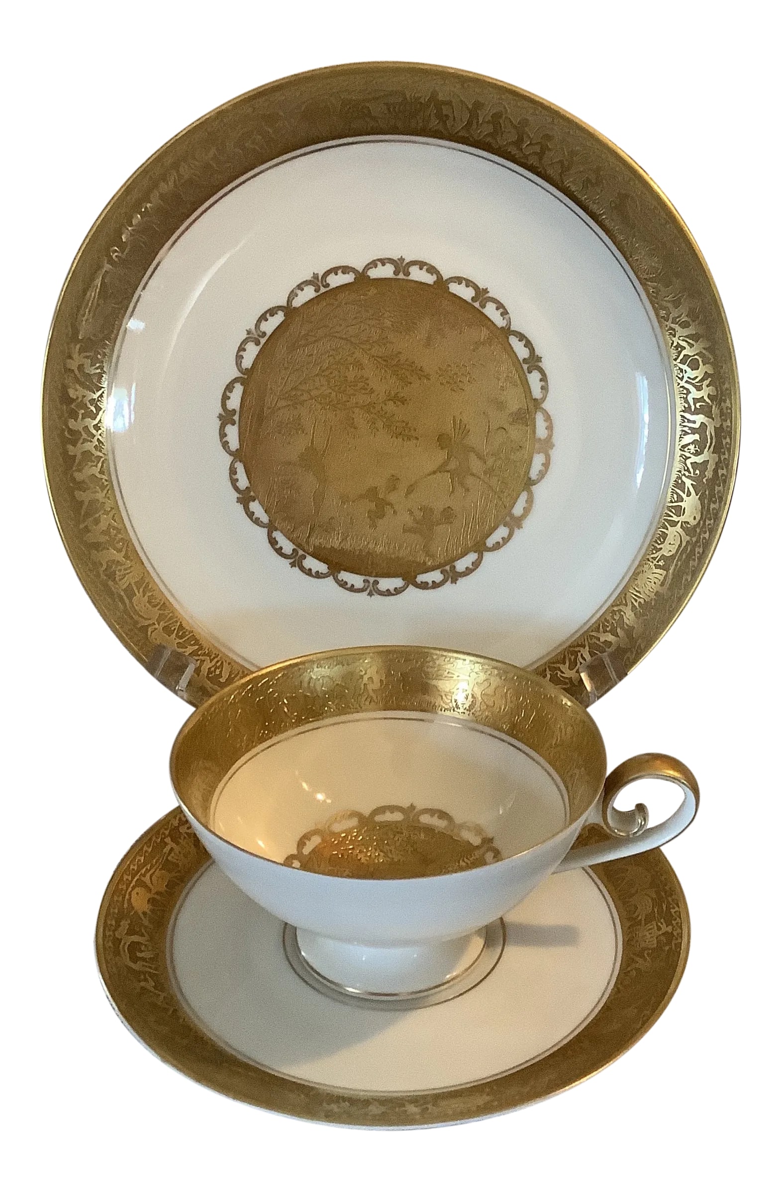 Bavarian Gilded Nymphs and Fairies Motif Tea Cup & Plates: Bavarian gilded tea cup trio. Depicts gold encrusted images of fairies and nymphs. Dessert plate measures 7 5/8" diameter; saucer measures 5.75" diameter; tea cup measures 4" diameter of top rim, 2.25