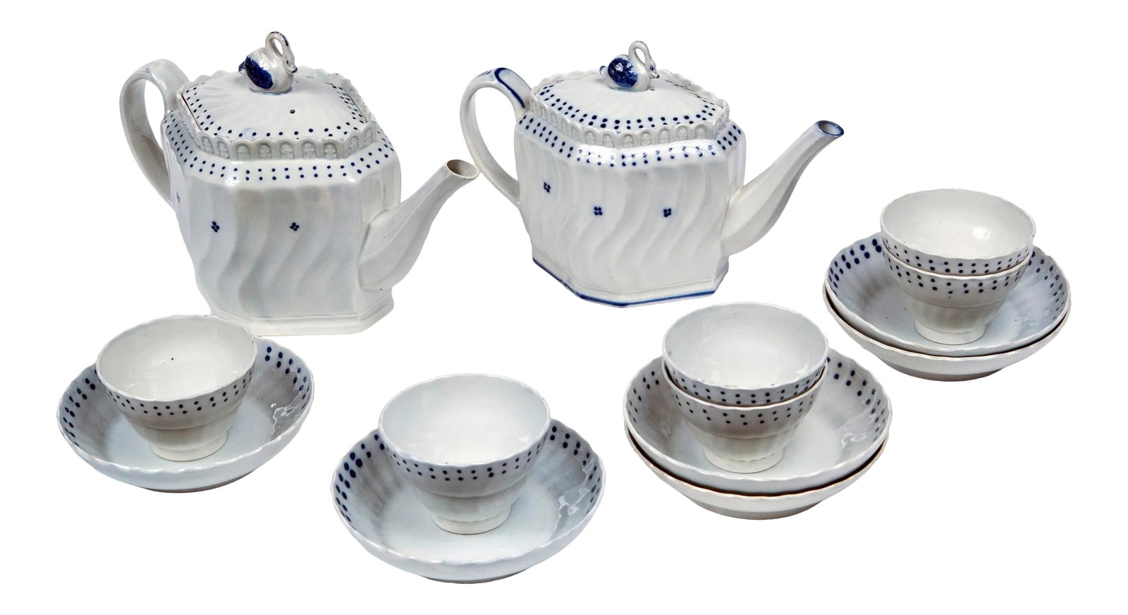 English Pearlware Tea Set, Early 19th Century: English Pearlware tea set, early 19th century. Two tea pots with swan finials. Six tea bowls and matching saucers. Delicate white porcelain with graphic blue glaze designs. Individual Measurements in 