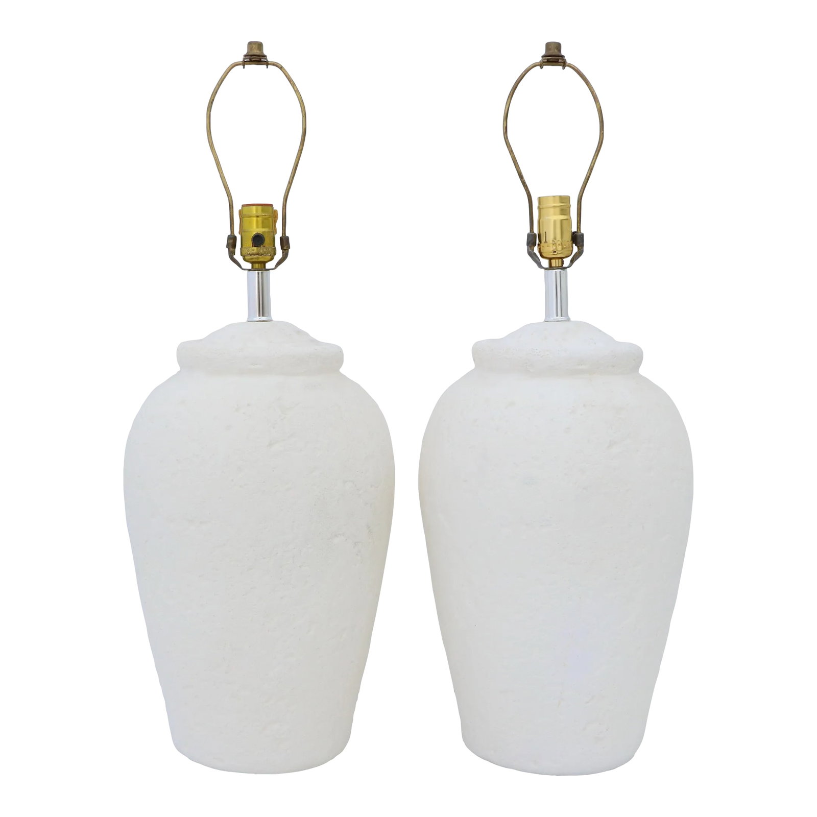 Postmodern White Plaster Urn Table Lamps - a Pair: Matching pair of heavily textured creamy white plaster urn table lamps, dating to the 1980's. Each measures 27.5" to the top of its finial, 22" tall to the top of its socket, and 10" across at its wid