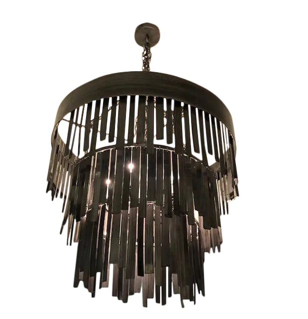 Made Goods Douglas Aged Silver Chandelier: Fringed metal strips featuring an antiqued silver finish, three tiers and maximum light. Condition: Alterations: Original Condition Unaltered Imperfections: Some Imperfections Condition Notes: Almost