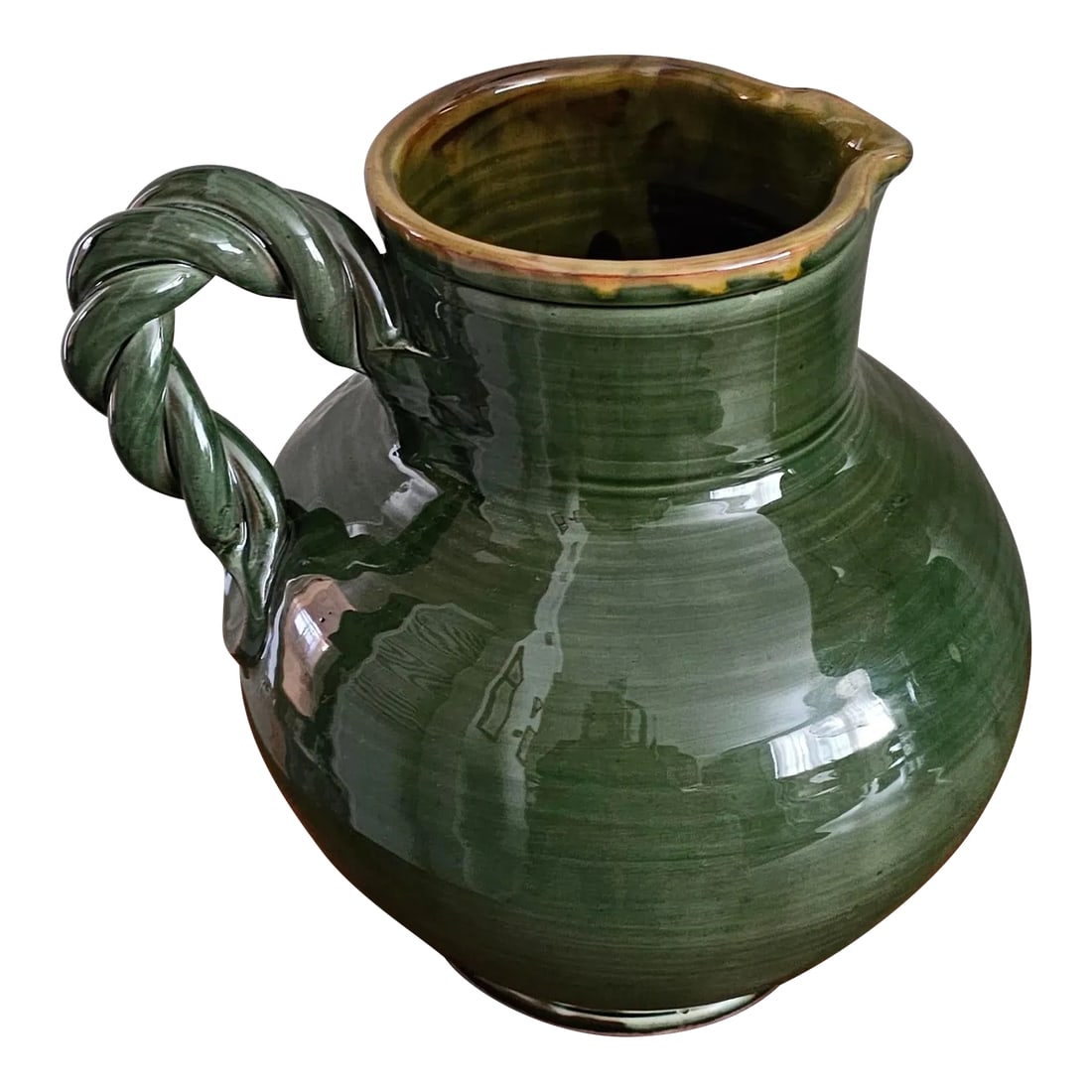 Suds & Co Hand Made Braided Handle Olive Green Color Water/Wine Pitcher: This beautiful Sud & Co hand made water/wine pitcher with its lovely rich high glazed dark olive green color and twisted handle is quite striking. It weighs 8 lbs. This is a multiple purpose item,