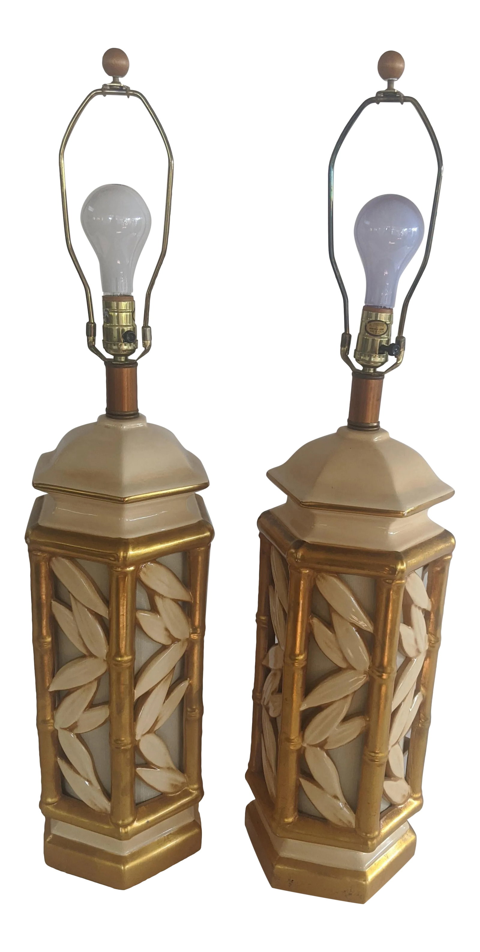 Vintage Hollywood Regency Ceramic Faux Bamboo Gilt Lamps - a Pair: Gorgeous pair of ceramic faux bamboo lamps in cream with gilt accents. 1960's. The inside bases of the lamps are illuminated, and may be turned on or off independently from the main light. Pristine