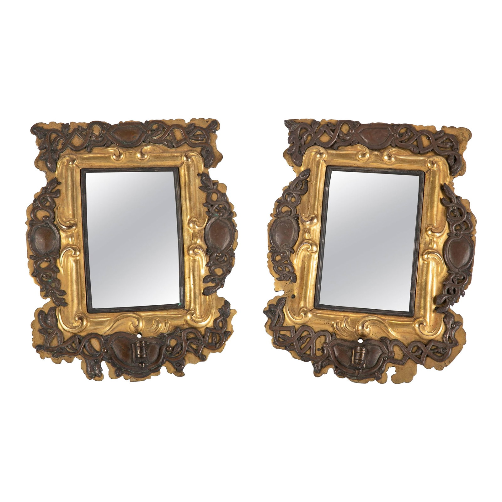 Pair of 18th Century Italian Gilt Brass and Silver Mirrors: Pair of Italianl Baroque small mirrors that were originally sconces. With silver arabesques overlaying gilt brass frames mounted on oak. The iron holders for candle arms still mounted on what are now
