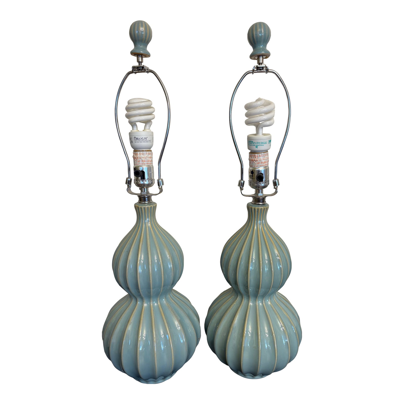Mid Century Modern Ceramic Lamps, a Pair: There is a three way lights on these ribbed French blue stacked ball lamps that radiate a beautiful golden light for any corner of your home. The ceramic bases are of a strong material that prove styl