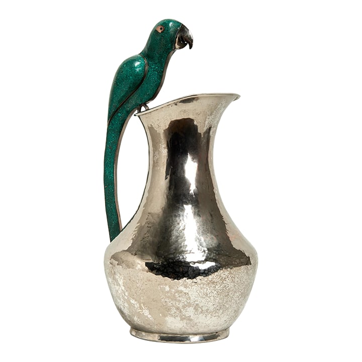 Vintage Silver Plate Pitcher With Parrot Handle by Alfredo Villasana: Standout mid century pitcher handcrafted in silver plate on hammered copper in classic form featuring a stone clad parrot as a handle. Stamped Villasana Mexico on the bottom. Condition: Alterations: