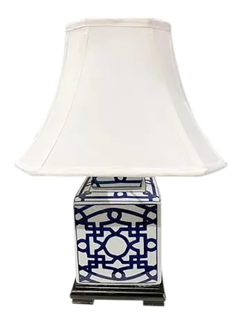 Blue and White Porcelain Table Lamp: Blue and White vase lamp is delightful with the dark blue pattern. The contrast is sharp on a walnut base with a square shade. The piece is in very good condition. The lamp itself is measured 7" wide