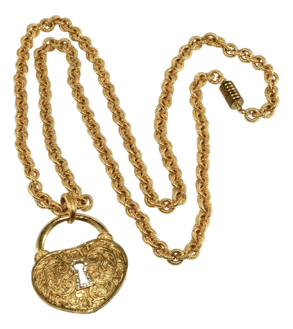 Vintage Graziano Heart Lock Necklace Gold-Plated: Heart shaped lock pendant with a keyhole outlined in clear rhinestones with textured chain. Metal is gold-plated. Marked Graziano on the back of the pendant. Dates to the 1990s. Pendant measures 2"