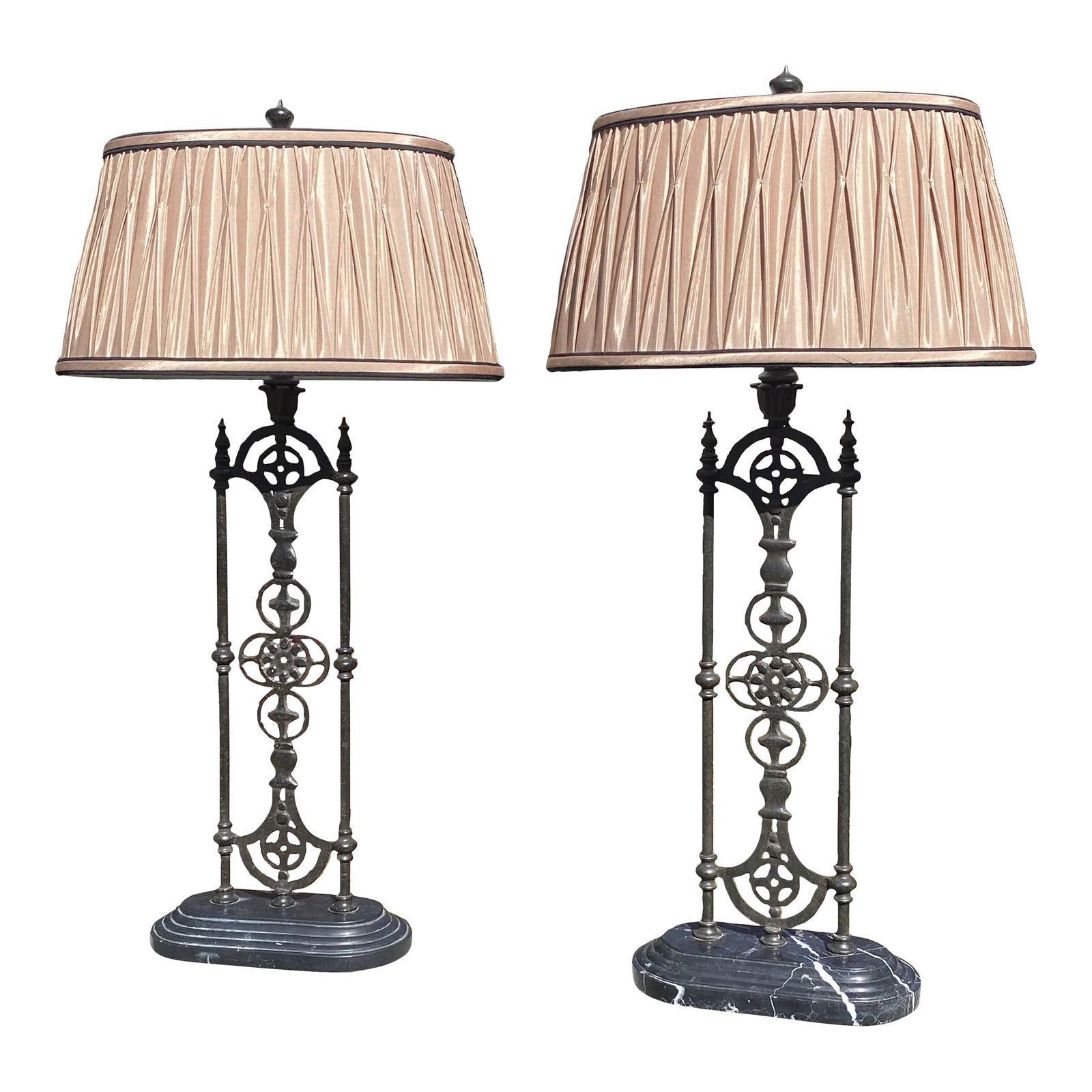 Pair of Wrought Iron Panel Buffet/Table Lamps: Tall lamps with wrought iron panels set on a marble base with pleated champagne bronze lamp shades. Versatile lamps can be used in many decor settings. Has app. 6' cord. Panel width is 6". Condition: 