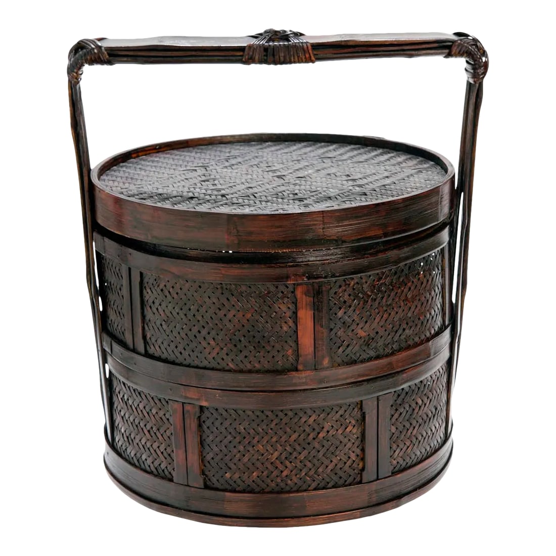 Late 20th Century Chinese Rattan Tiered Lunch Box: Chinese rattan two-tiered nested box. Born in early 20th century China, this basket features a circular lid adorned with a beautiful woven pattern. The basket showcases a large handle allowing for eas