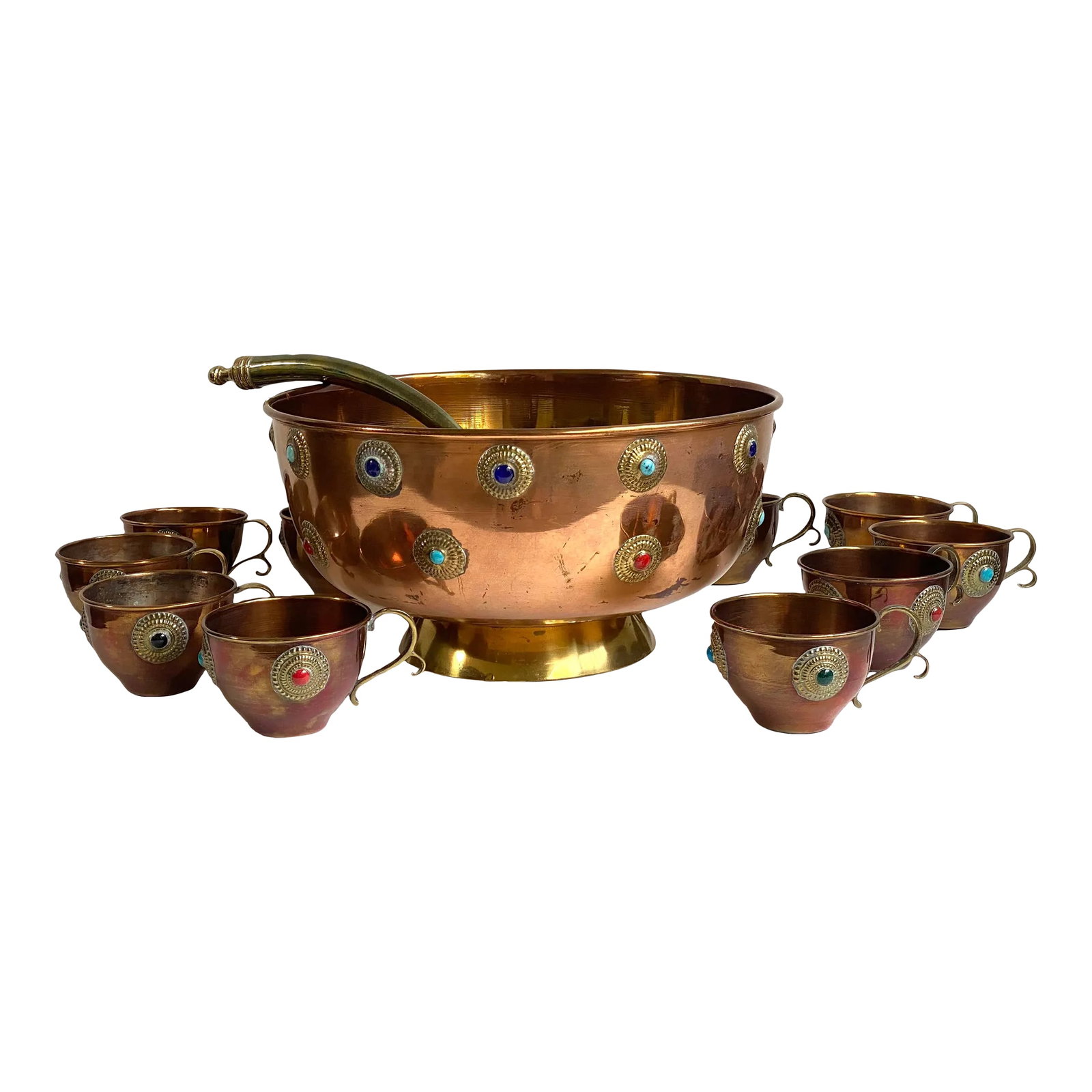 Mid 20th Century Mid Century Bejeweled Copper & Brass Punchbowl Set 12 Pieces: Stunning, bejeweled copper punchbowl with brass accents. Bezel set gemstones decorate the bowl and cups. Includes brass ladle and 10 bejeweled copper and brass cups. Cups have hooks to hang on the lip