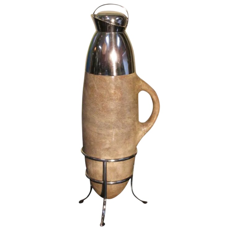 Vintage Aldo Tura Lacquered Goatskin Carafe on Stand: A rare Mid-Century Italian lacquered goatskin carafe by Aldo Tura. The beautiful goatskin is in a taupe color with a silver-plated spout, tripod stand base, and stopper with a cork bottom. Interior is