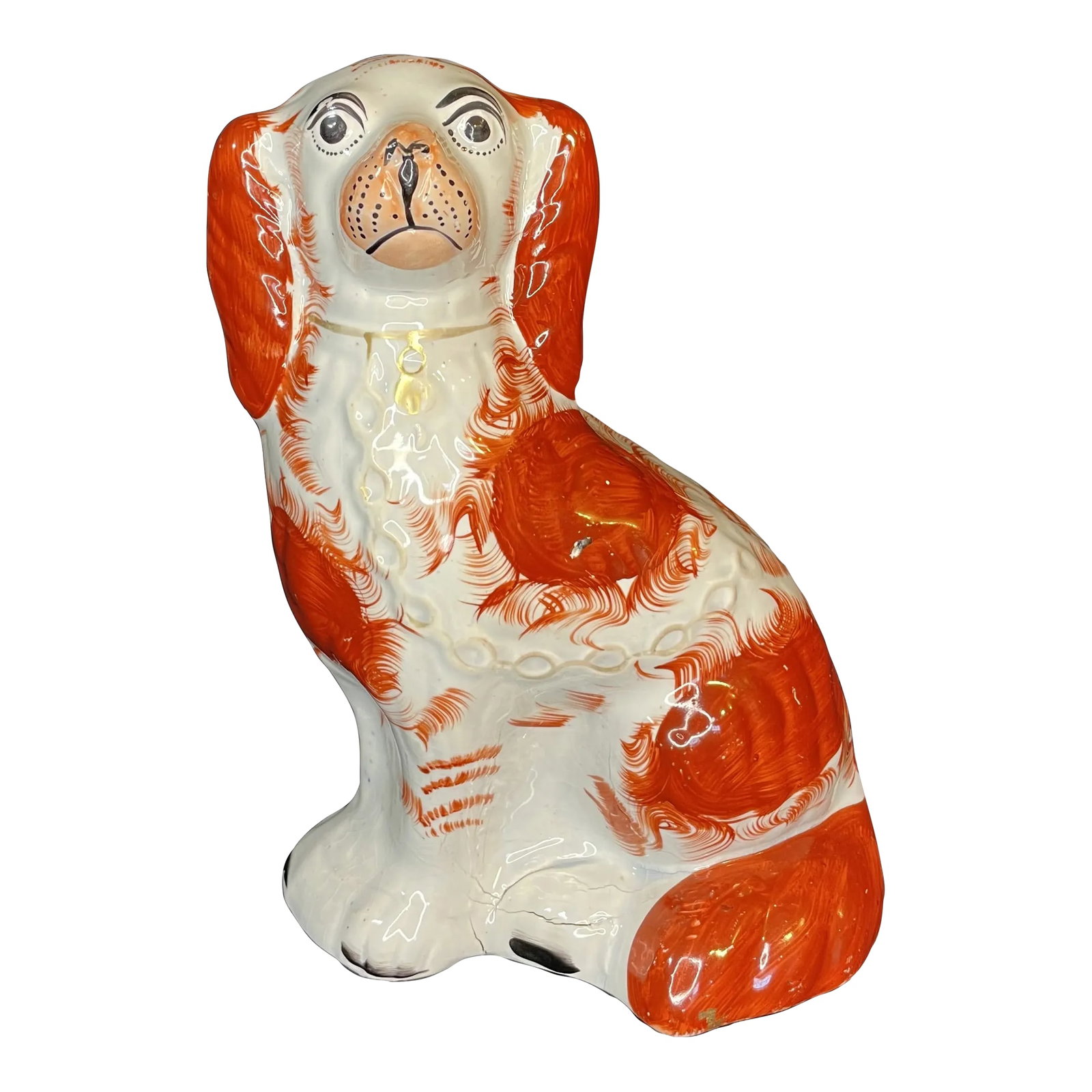 Staffordshire Spaniel Dog Figurine England Circa 1870: A 19th-century English Staffordshire spaniel dog, hand-painted with traditional detailing and historic charm. Our Staffordshire ceramic spaniel, seated with tail in the front, is hand painted with a