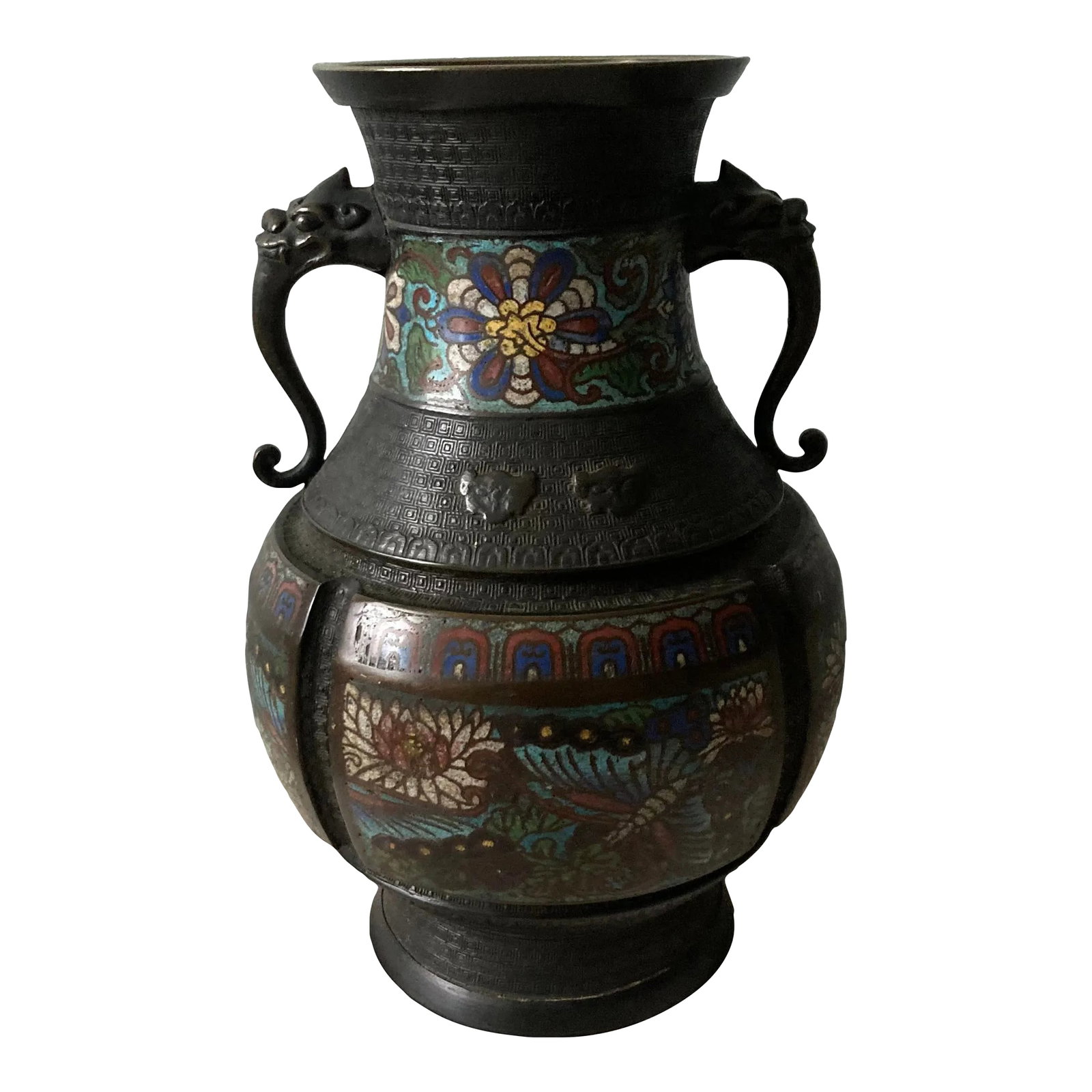Mid 19th C Bronze Japanese Champleve Urn With Foo Dog Handles: Champleve is an enameling technique that enamels raised surfaces on a cast brass or bronze object and then fired. Not to be confused with cloisonne that solders wires in a design to a flat surface and