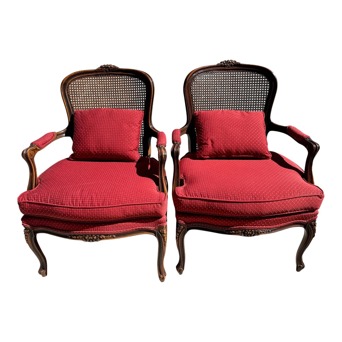 Antique French Louis XV Cane Back Berger's Chairs-A Pair: Beautiful French Louis XV Carved floral detail on legs and top back of chair. Has a cane back. Upholstered seats with matching pillows. Red with gold dots. Perfect for a Rustic European look. Also per
