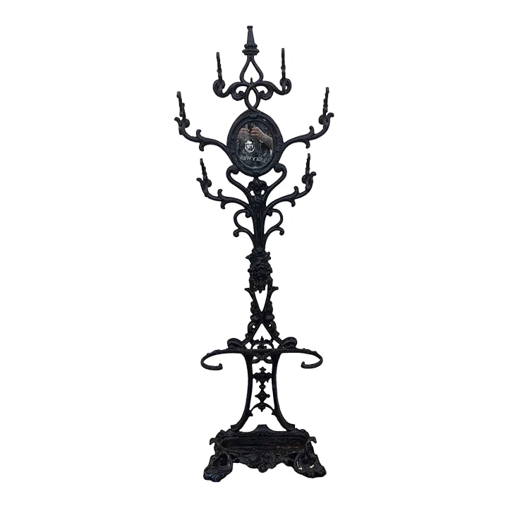 Early 20th Century Six Armed Iron Hall Tree With Small Center Mirror and Two Umbrella Racks and One: Victorian six armed Iron Hall Tree with small center mirror and two umbrella racks and one large drip tray. Mirror is face sized flat glass , set into middle of upper frame. Condition: Alterations: