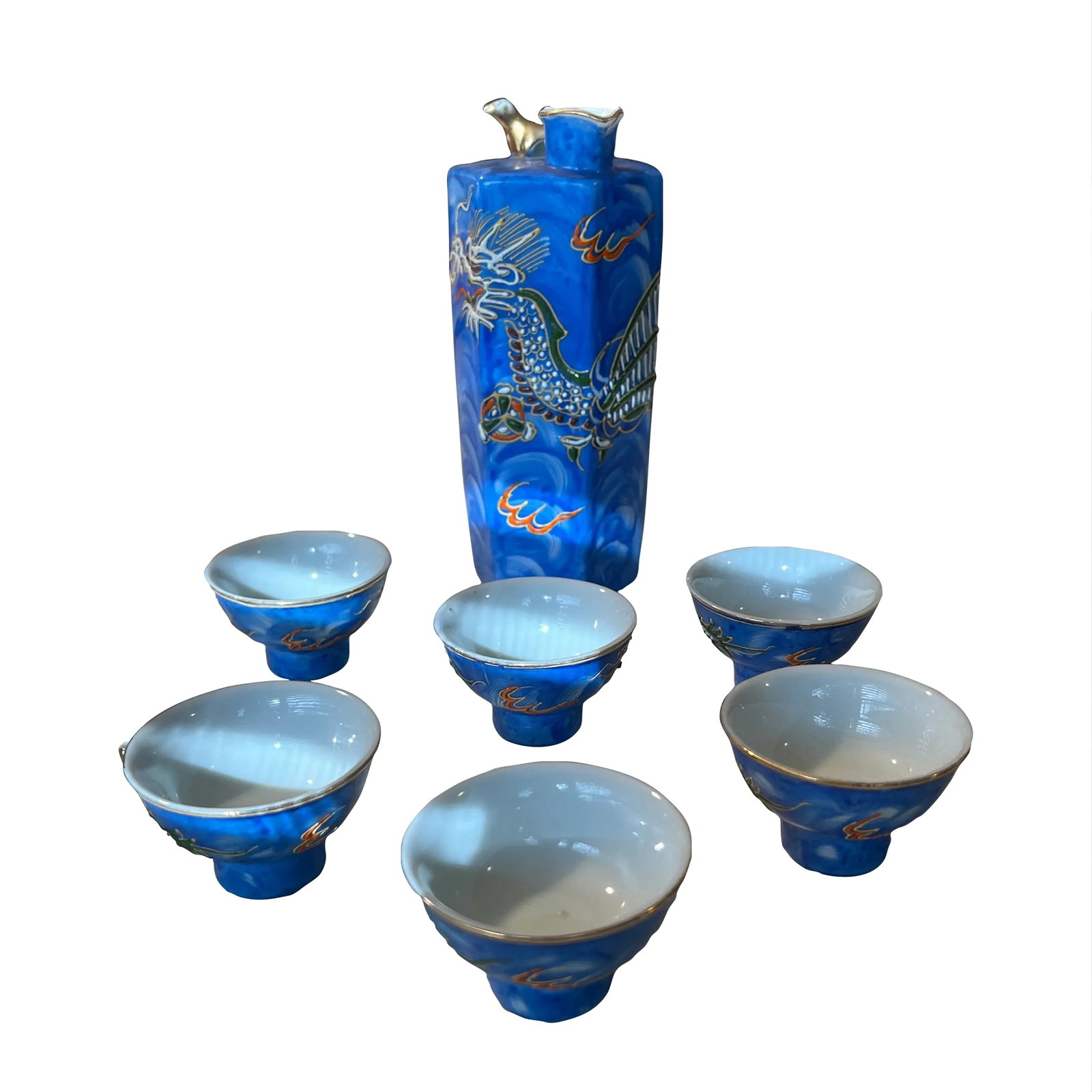 Vintage Moriage Dragonware Sake Set- 7 Pieces: Hand painted sake set in a beautiful shade of blue trimmed in gold with raised dragon relief. I love how the fire in bursts of orange and yellow pop out from the blue background. Set of 7. Condition: 
