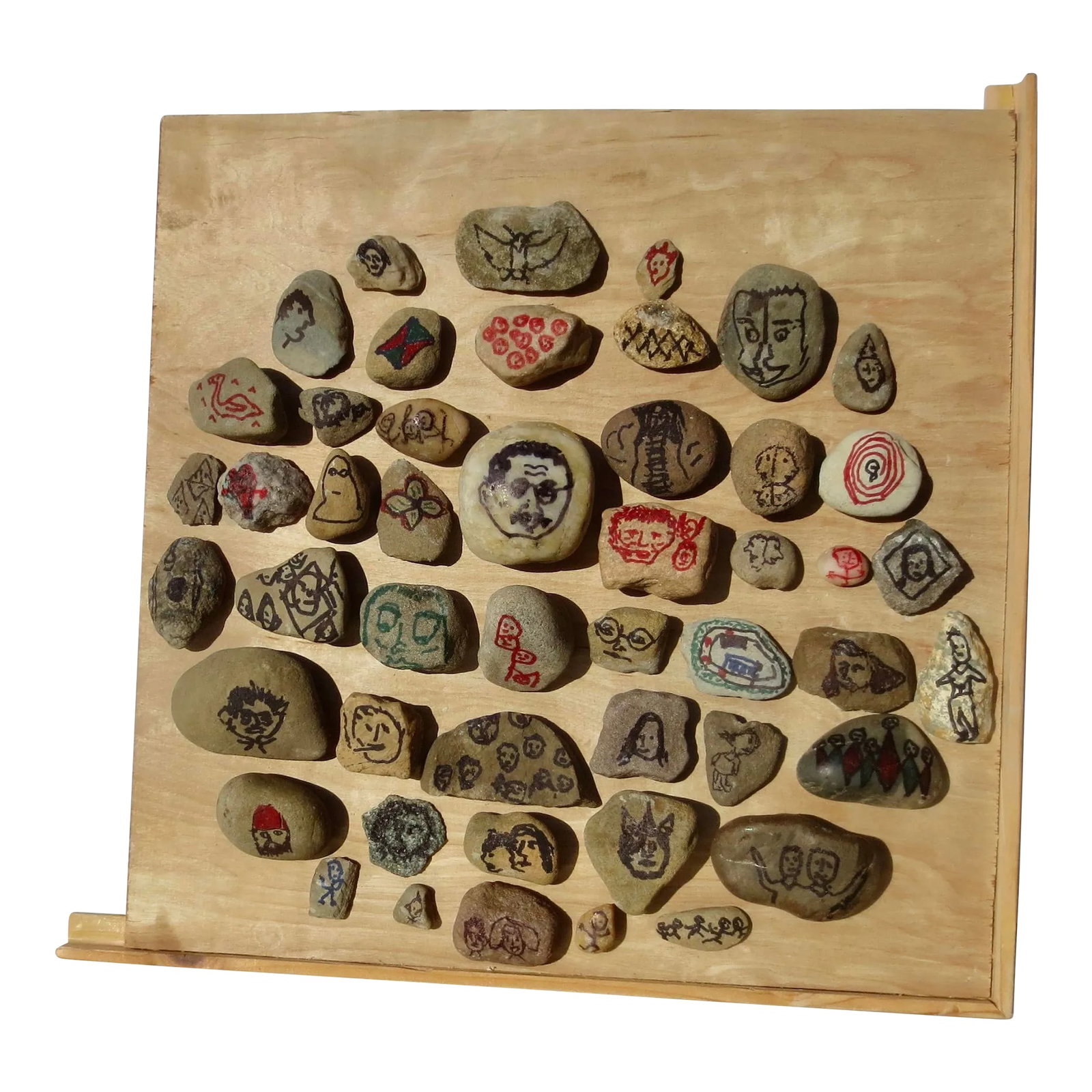 Family Album From the Debris Fields of the Moon by Basil Mavrovitis 2023: Basil Mavrovitis ( American 1955) outsider artist, made a stone collage of marker portraits mounted to equally discarded surfaces. Graphic and to-the-point collections of members of the family circle 