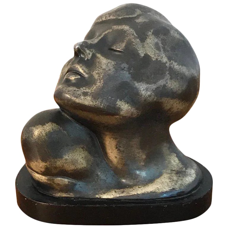Early 20th Century Art Deco Zinc Flapper Portrait Bust: Art Deco zinc flapper portrait bust, with her head tilted wearing a bobbed haircut, raised on a ebonized wood plinth base. Condition: Alterations: Unknown Imperfections: Some Imperfections Condition
