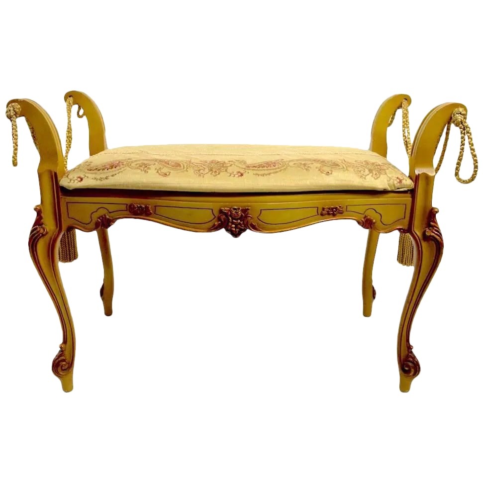 Romantic Vanity Bench in the French or Italian Style: Decorative and romantic vanity bench, probably American manufacture, in the Continental style. Rope tassels, carved cabriole legs with upholstered pad seat, upholstery shows wear. Condition: Alteratio