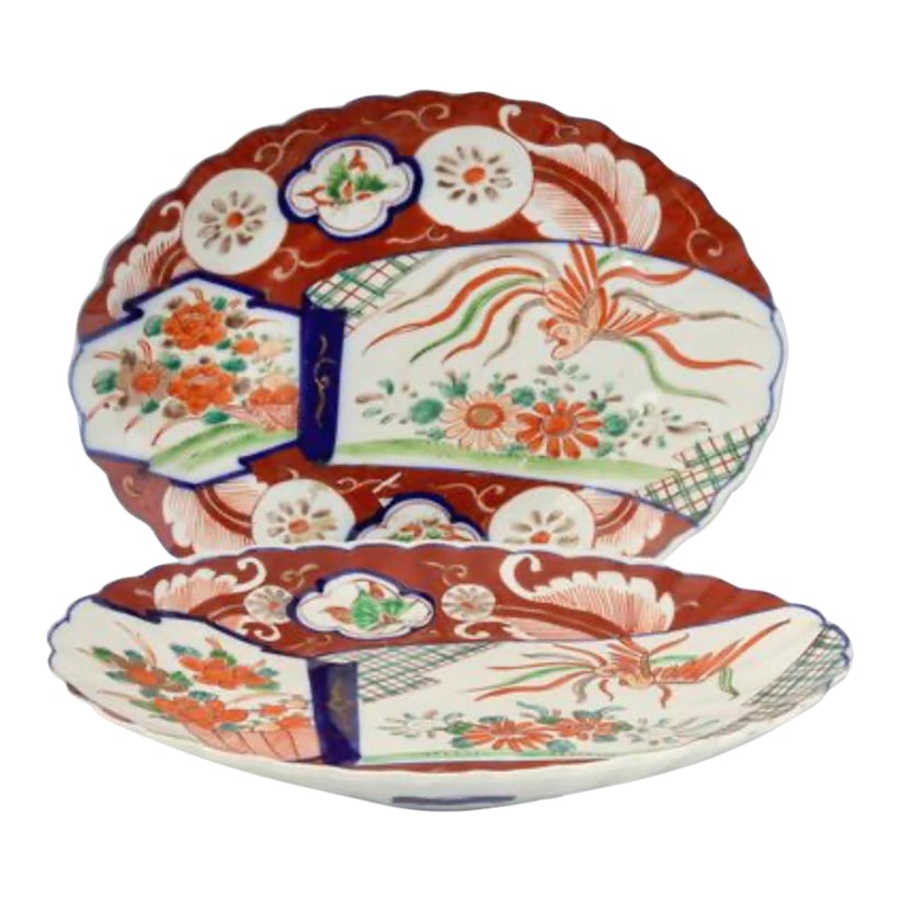 19th-Century Scalloped Edge Japanese Imari Plates: An exquisite pair of 19th-century Japanese Imari porcelain plates, each showcasing the artistry and color mastery that defined Japan's most celebrated export porcelain. The scalloped rims and rich