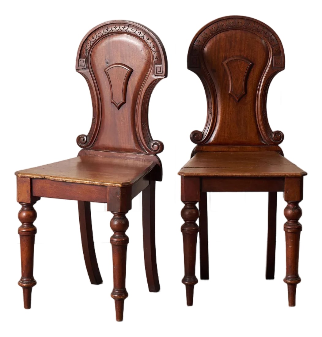 Pair of Late 19th Century Victorian Hall Chairs With Petite Floral Cravings: Pair of Victorian hall chairs with carved floral backs, shaped seats, and a warm aged finish. Classic English design with sturdy construction and original character. Condition: Alterations: Original