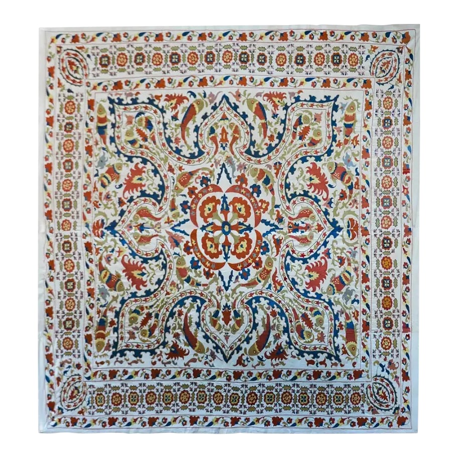 Vintage 'Leaping Fish' Suzani: A striking vintage Uzbek Suzani with the most wonderful hand-embroidered pattern containing large-scale flowers, leaves, and vines, and myriad leaping fish, all woven in brilliant reds, golds, and