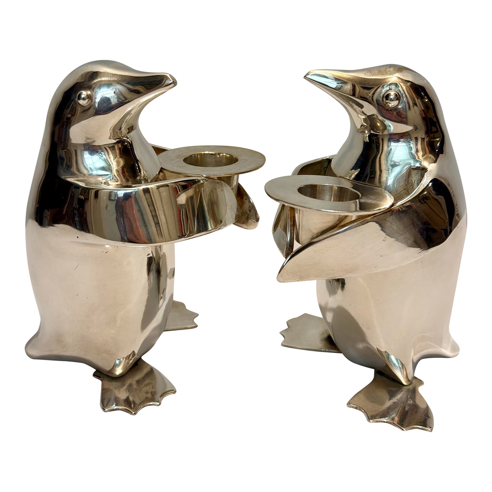 1990's Restoration Hardware Silver Plated Penguin Candle Stick Holders - A Pair: Bring a dash of sophisticated whimsy and sculptural charm to your tablescape with this delightful pair of vintage 1990s silver-plated penguin taper candle holders. Originally produced for Restoration 