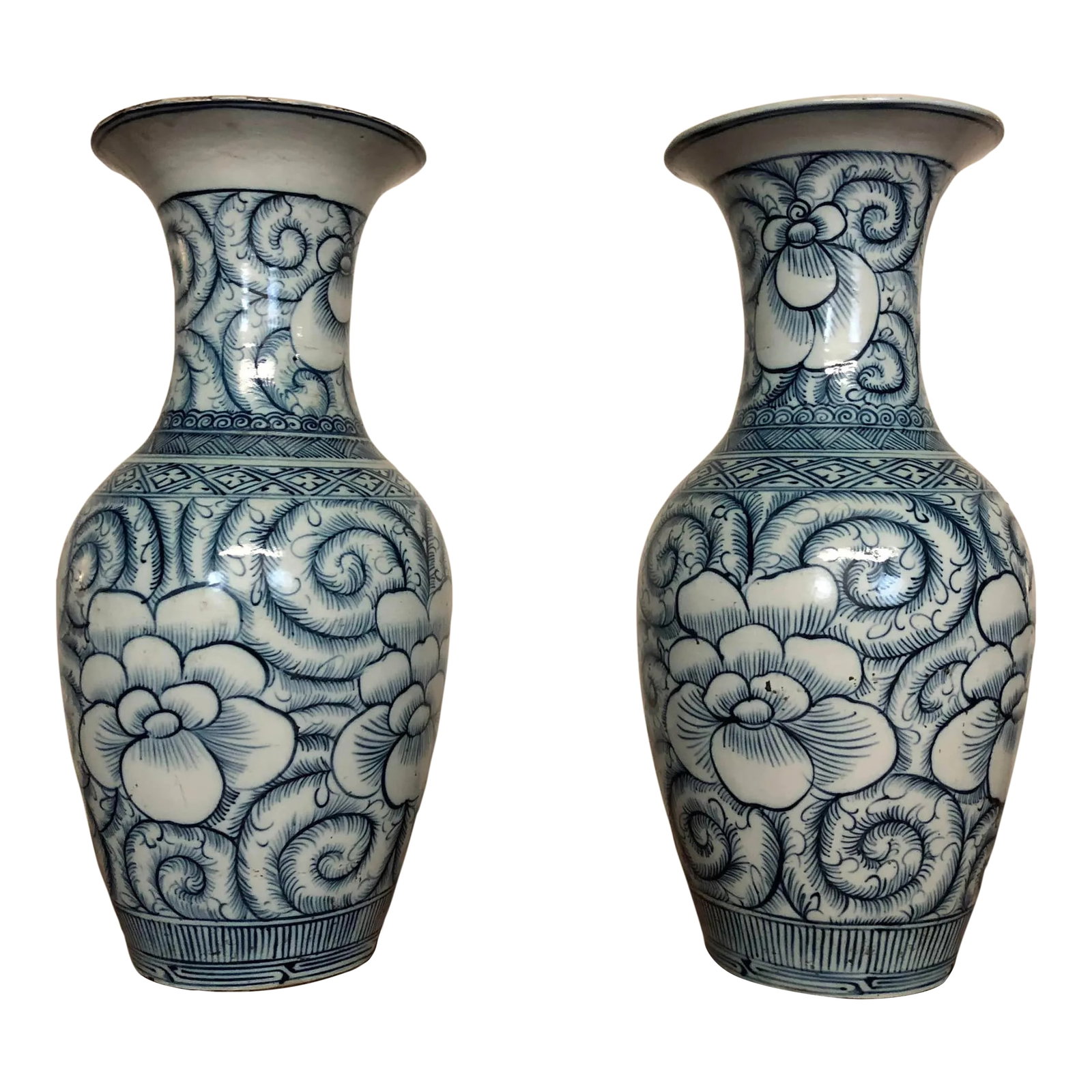 Pair of Blue and White Large Vintage Chinese Porcelain Vases: Pair of blue and white large vintage Chinese porcelain vases with a floral design. This vintage pair for white and blue vases have character and patina that shows their age. 9" in diameter, 18.75" hig