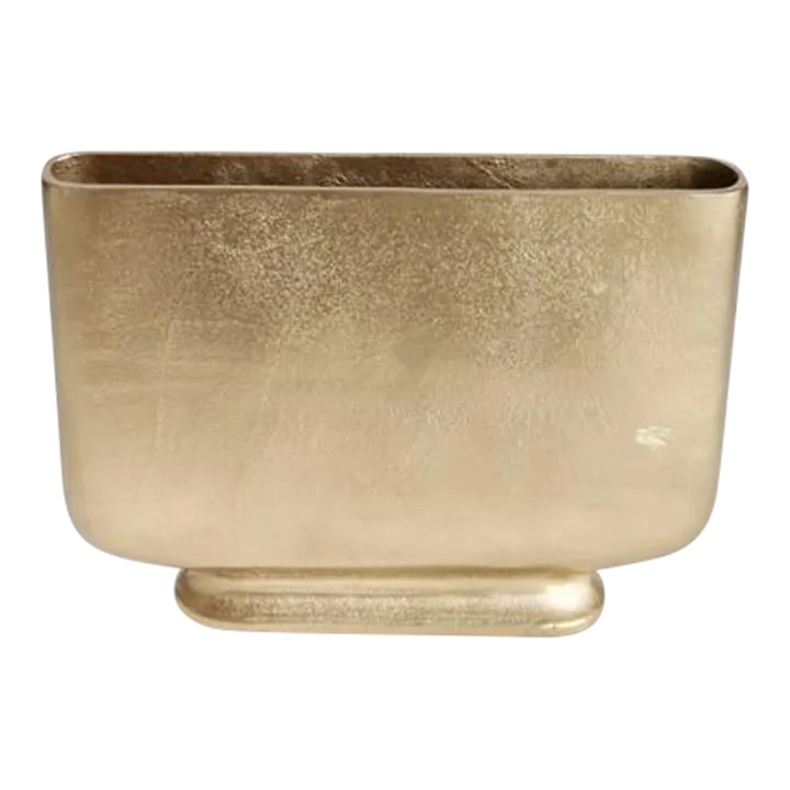 Large Gold Pendleton Metal Vase: The Large Gold Pendleton Metal Vase Dimensions: 15.75 x 3 x 11.5 Designed with a shallow profile, this simple vase is perfect for narrow shelving and alcoves. Large in scale, it is ideal for tall stem