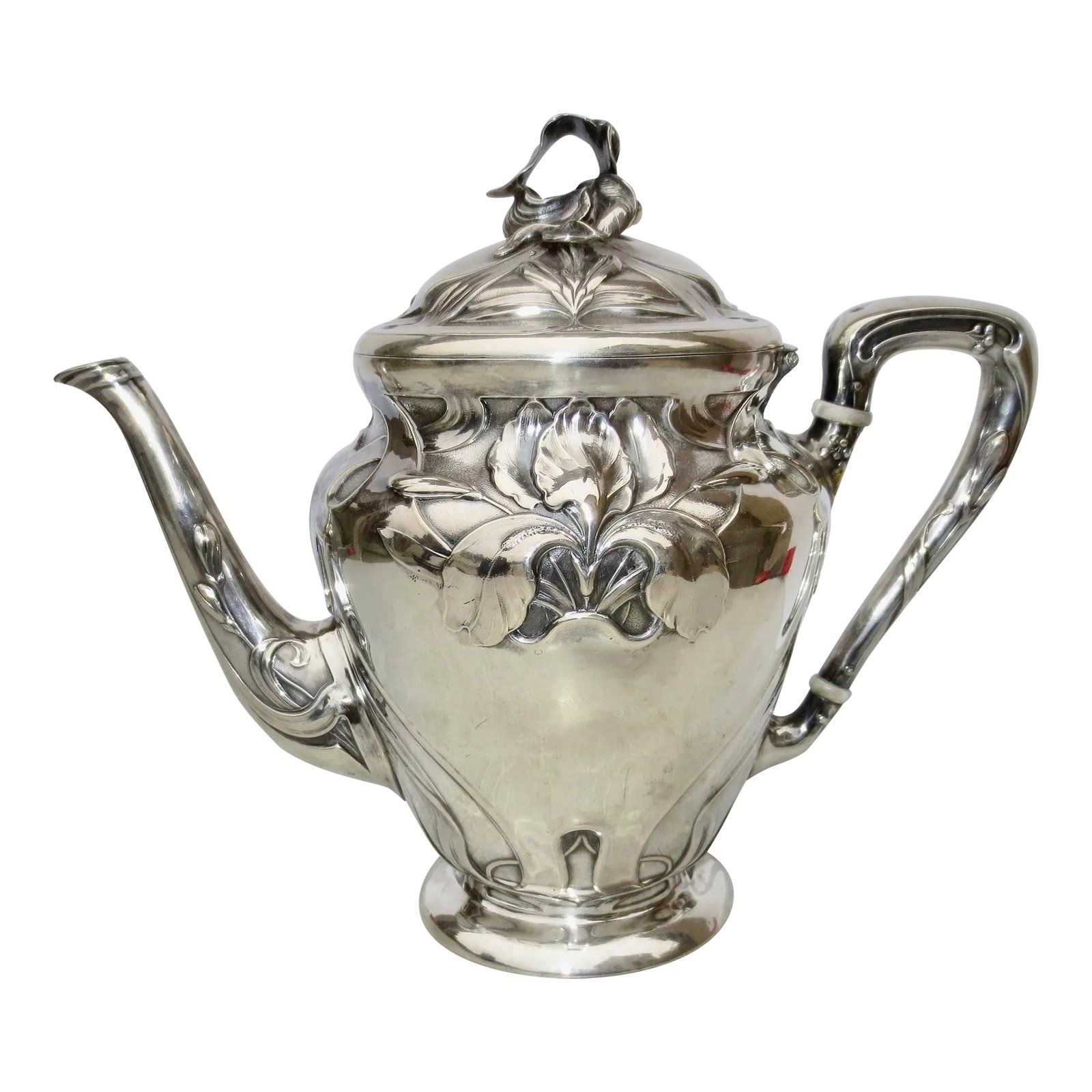 Silver-Plate Art Nouveau Tea Pot: Silver-plate continental Art Nouveau Teapot. Circa 1900. High-style art nouveau pattern of lady slipper finial and Iris crests, scrolling blades of the foilage ornament the borders and over the spout 
