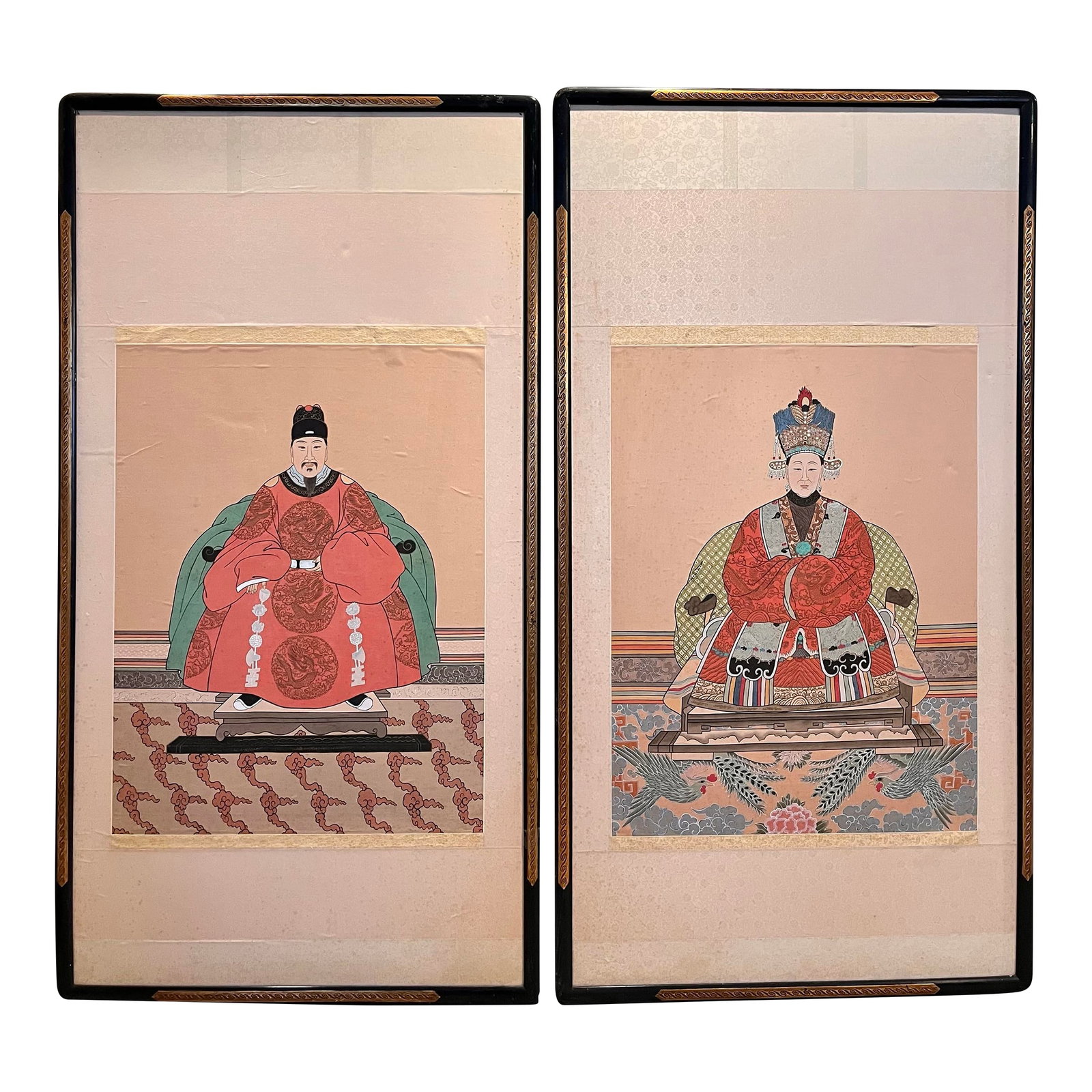 Early 20th Century Antique Large Scale Chinese Ancestor Portraits Painted on Silk - A Pair: This pair of large-scale, oversized antique Chinese ancestor portraits, likely from the Qing Dynasty (1644-1912), depicts an emperor and empress. These silk paintings traditionally honored deceased fa